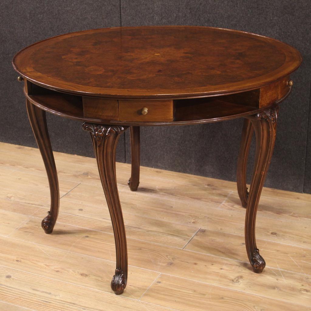 Italian game table from the mid 20th century. Furniture of excellent quality carved and veneered in walnut, beech, burl, mahogany and fruitwood. Table of particular construction resting on five sculpted and chiseled legs with curly feet (see photo).