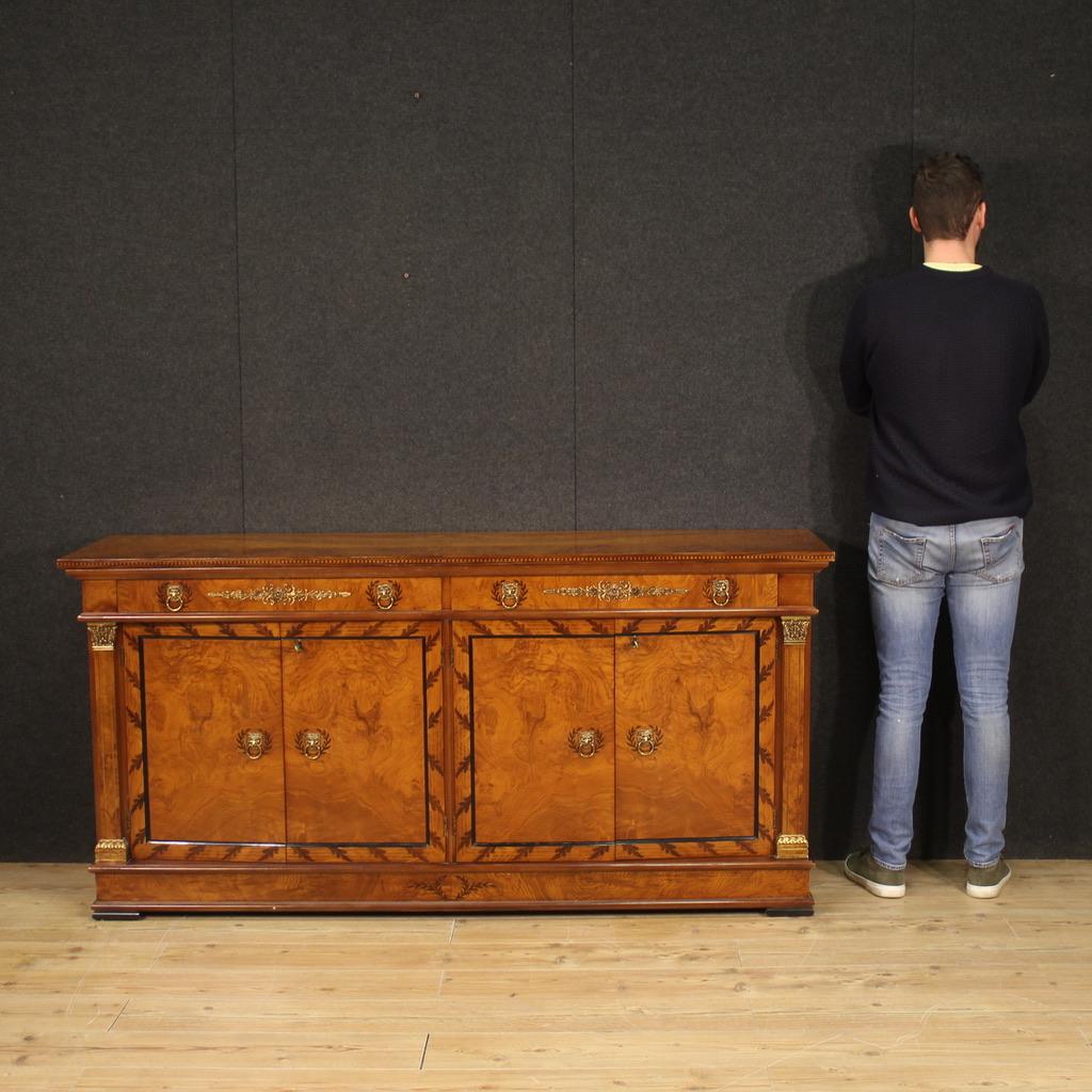 Italian sideboard from the second half of the 20th century. Furniture carved and veneered in walnut, maple, exotic wood, ebonized wood and fruitwood in a neoclassical style. Straight sideboard on the front and on the sides, with 4 doors and 2