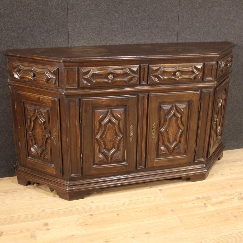 Italian sideboard from the mid-20th century. Notched furniture carved in oak and beech wood (there are plywood elements, backrest, top, drawer bottoms) in baroque style of beautiful line and pleasant decor. Sideboard equipped with 4 doors and two