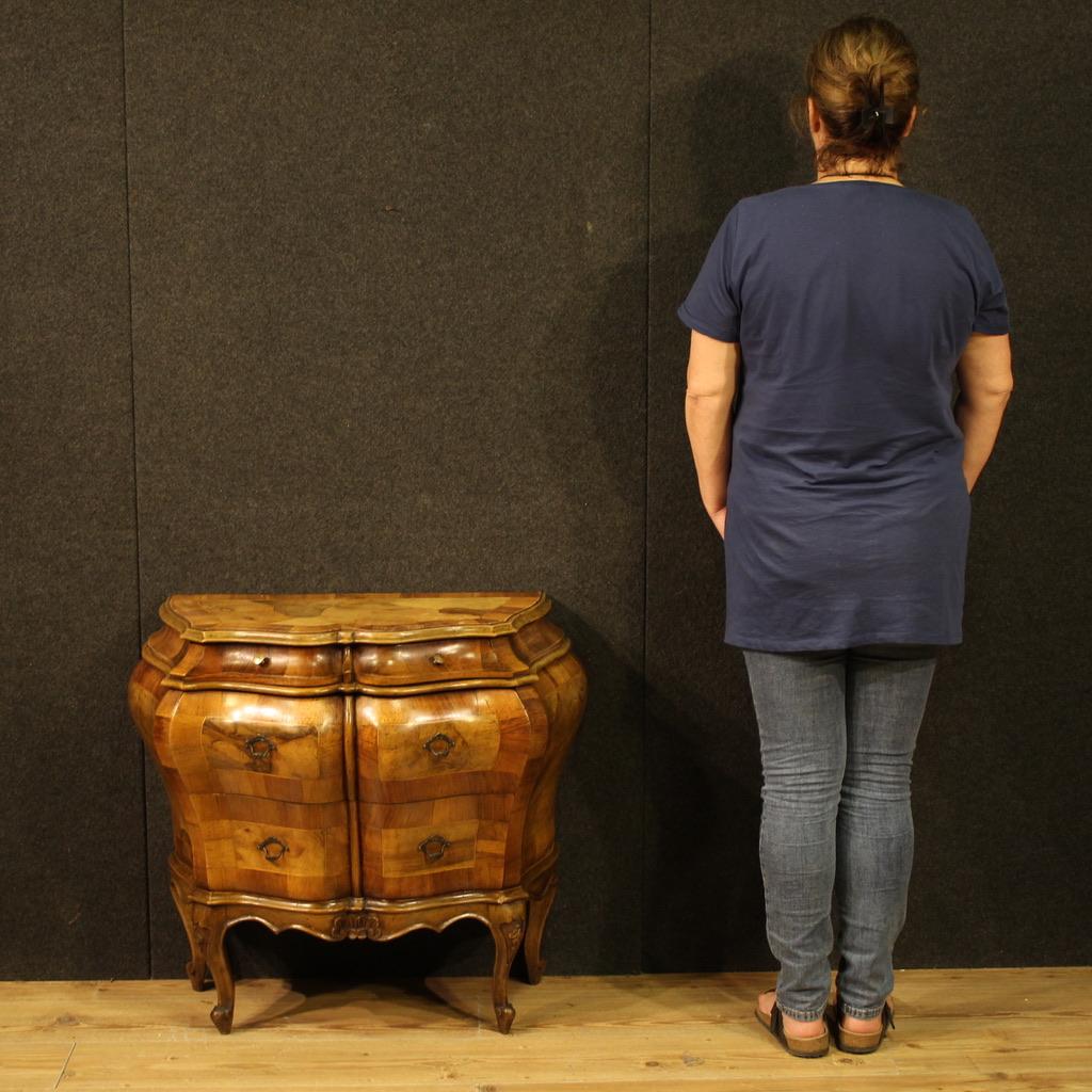 Small Italian chest of drawers from the second half of the 20th century. This curved furniture is carved and veneered in walnut, maple, and beech, has beautiful lines and a pleasing décor. This commode features two spacious drawers at the bottom and