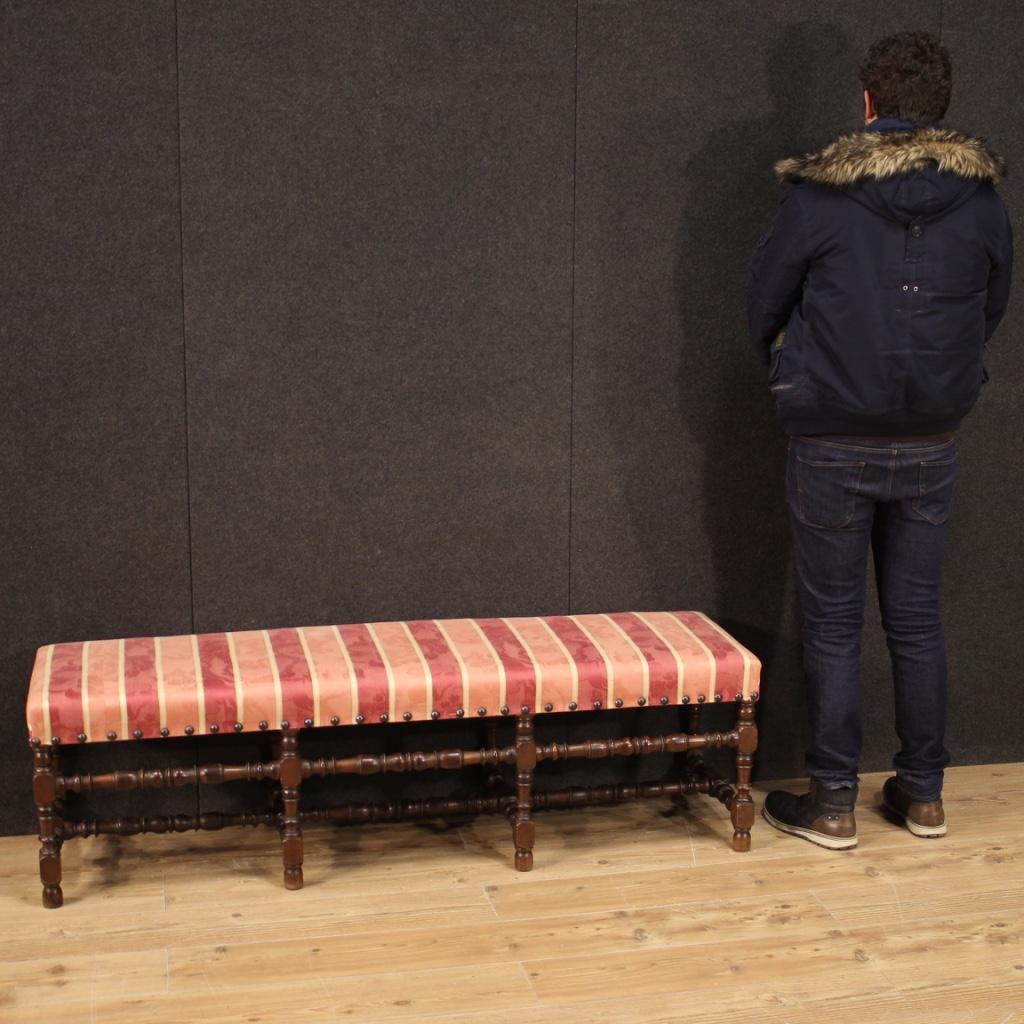 Italian bench from the mid-20th century. Spool style carved furniture in walnut patinated beech wood of beautiful line and pleasant decor. Seat covered in fabric (not original, replaced during the 20th century) in good condition, without stains or
