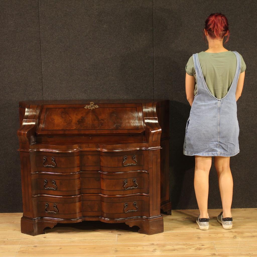 Venetian bureau from the mid-20th century. Furniture with a wavy front and sides, inlaid with walnut and mahogany wood, beautiful lines and pleasant furnishings. Bureau equipped with three large external drawers plus fall-front. The interior of the
