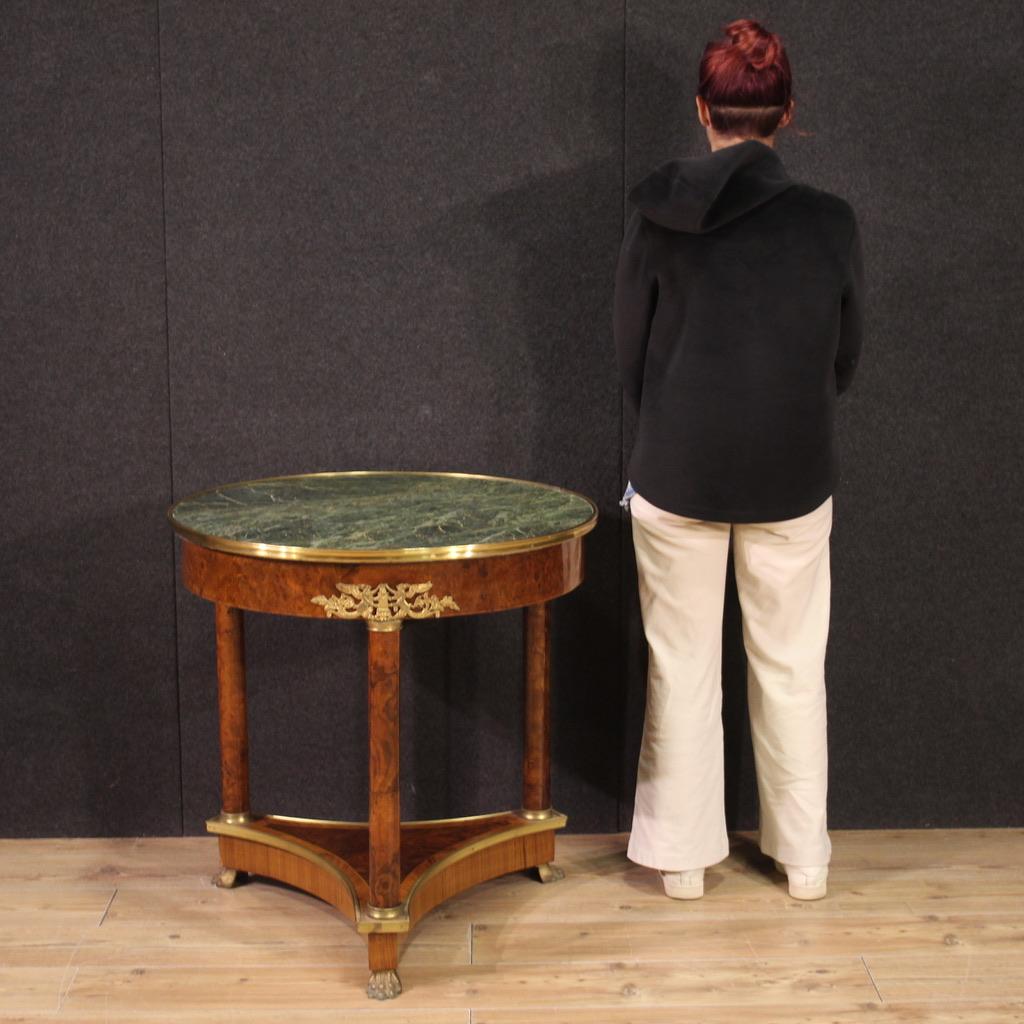 Elegant French living room table from the second half of the 20th century. Empire style furniture veneered in walnut, burl, rosewood and maple. Table richly adorned with brass and gilded and chiseled metal (see photo). Recessed marble top with