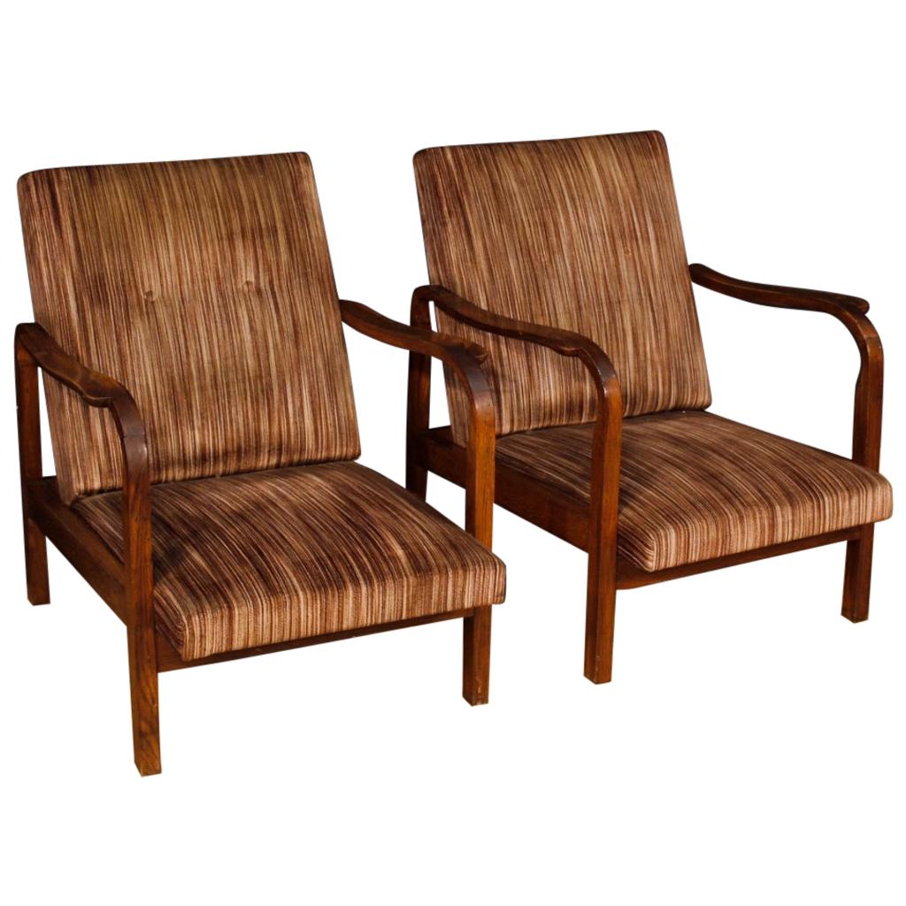 Pair of Italian armchairs from the 1970s-1980s. Design furniture with wooden structure covered in striped fabric of beautiful line and pleasant decor. Armchairs ideal to be inserted in a living room or studio of good comfort. Padding in good