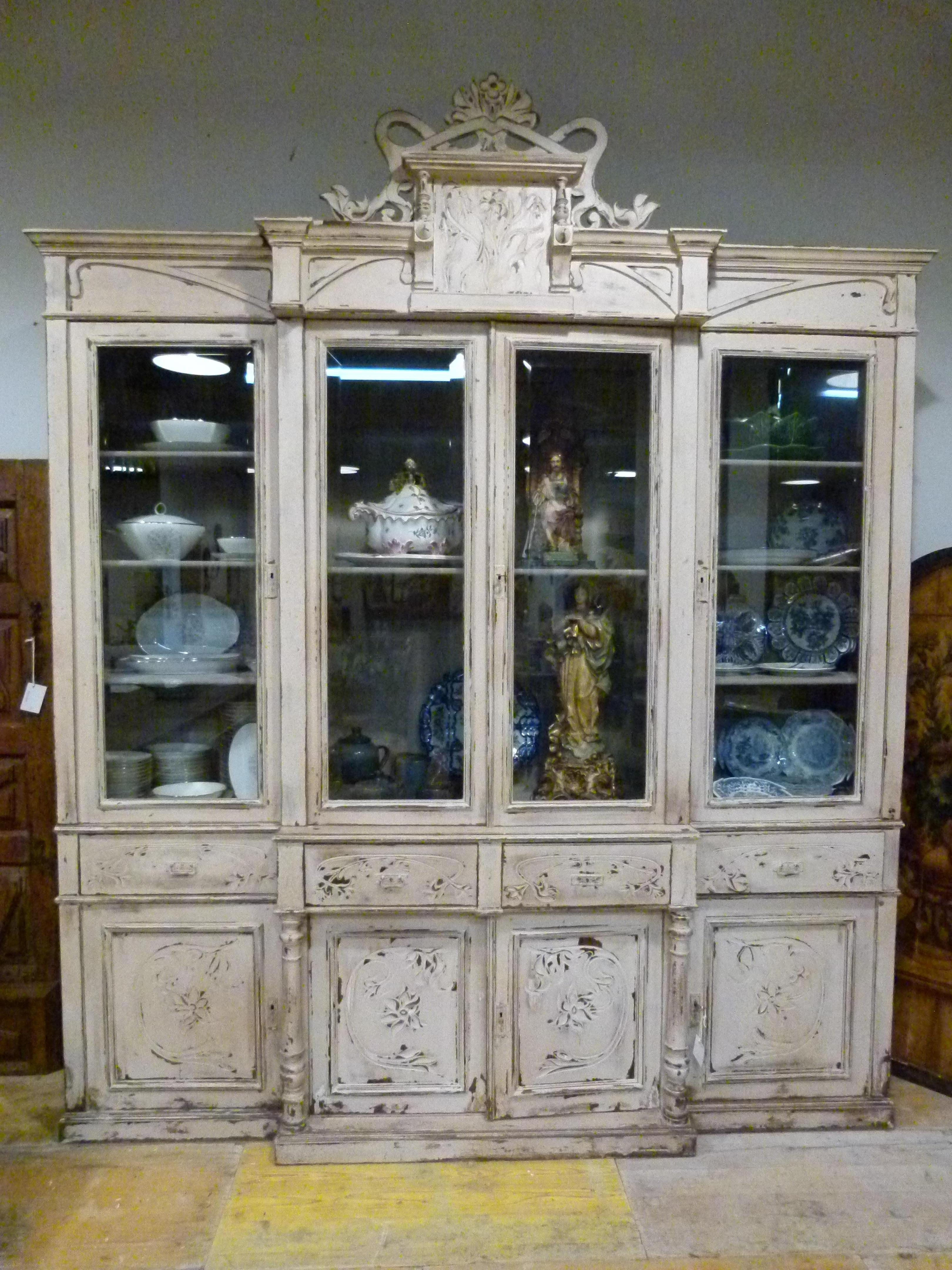 20th century wooden cabinet with 6 doors and 4 drawers. White patinated. Plenty of space for dishes or books as  it works good with both.
A nice piece that will bring the rustic atmosphere to your house.