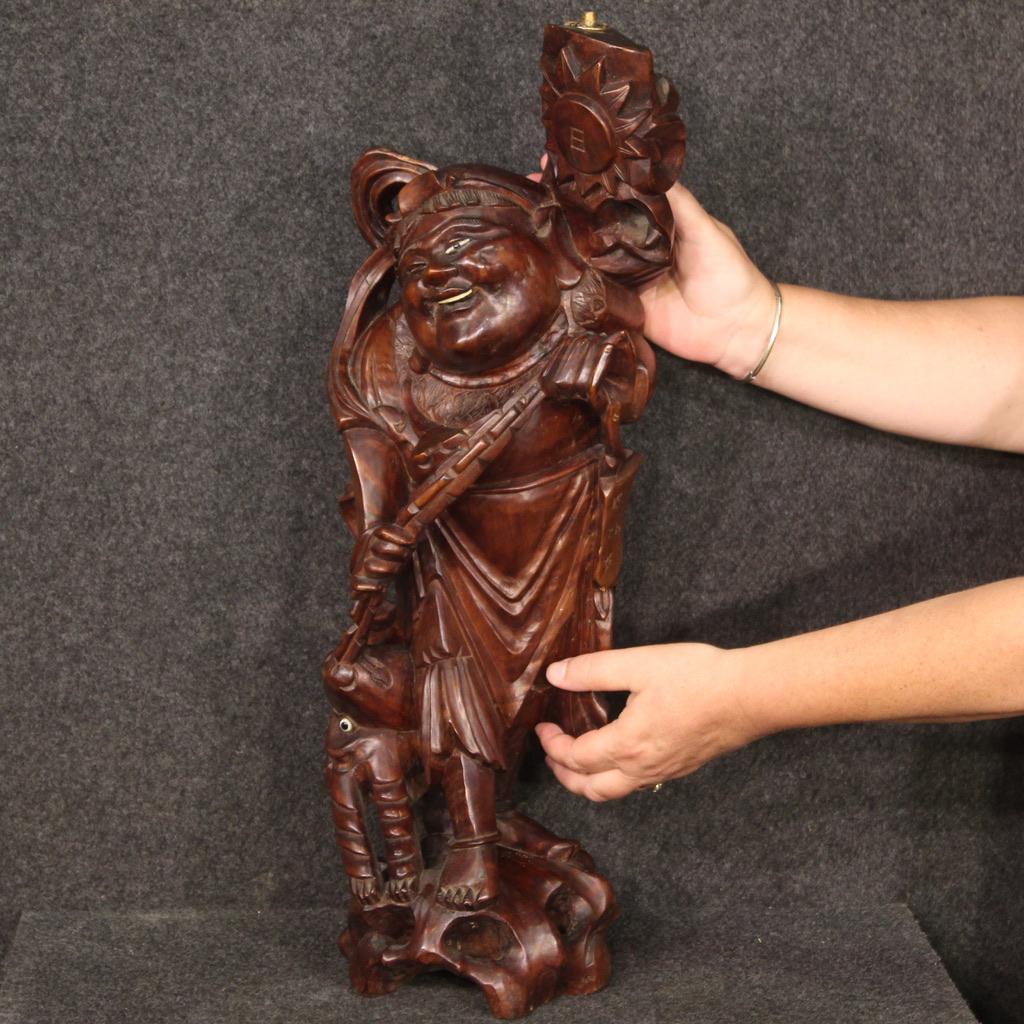 Oriental sculpture from the mid-20th century. Nicely carved and worked exotic wooden object depicting a character with an animal on a chain of good quality. Sculpture made from a single wooden block, of good size, modified during the 20th century to