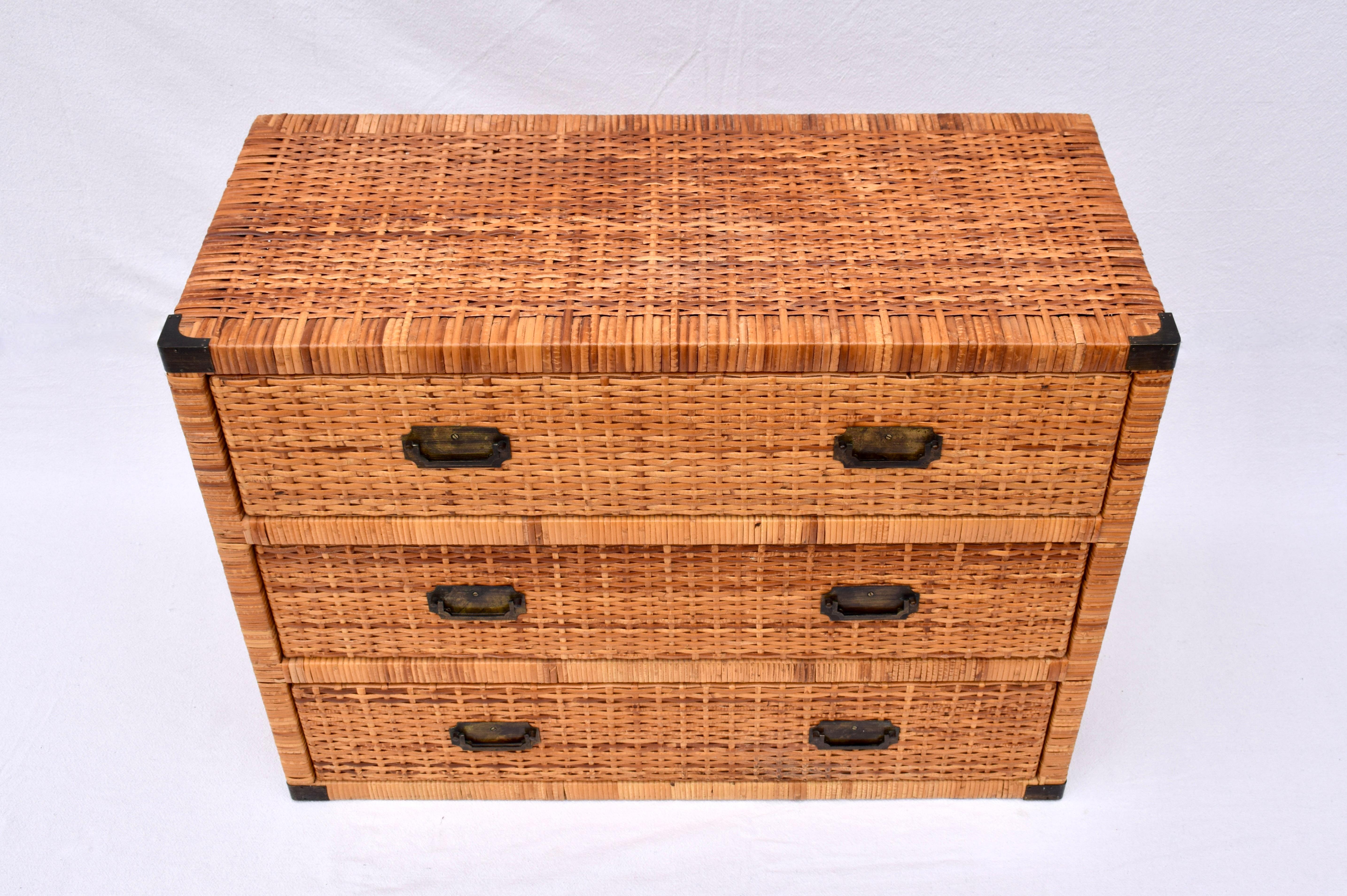 Woven rattan chest of three drawers in the campaign style with rich honey tones & all original brass hardware. Generous storage in beautifully maintained condition ready for use..