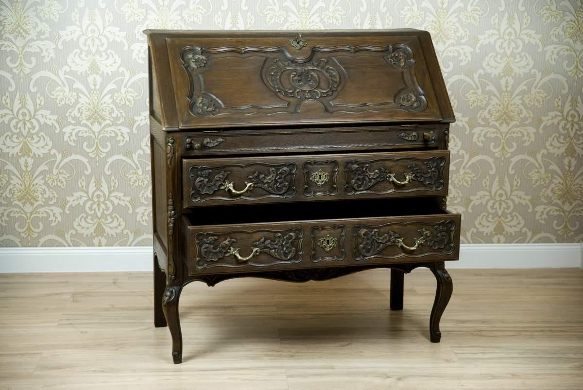 Scrittoio Rococò Revival in Oak marrone, inizio XX secolo

Questo mobile, realizzato interamente in quercia, risale alla prima metà del XX secolo. È composto da due cassetti e da una scrivania che si apre ad angolo. L'intero pezzo è sostenuto da