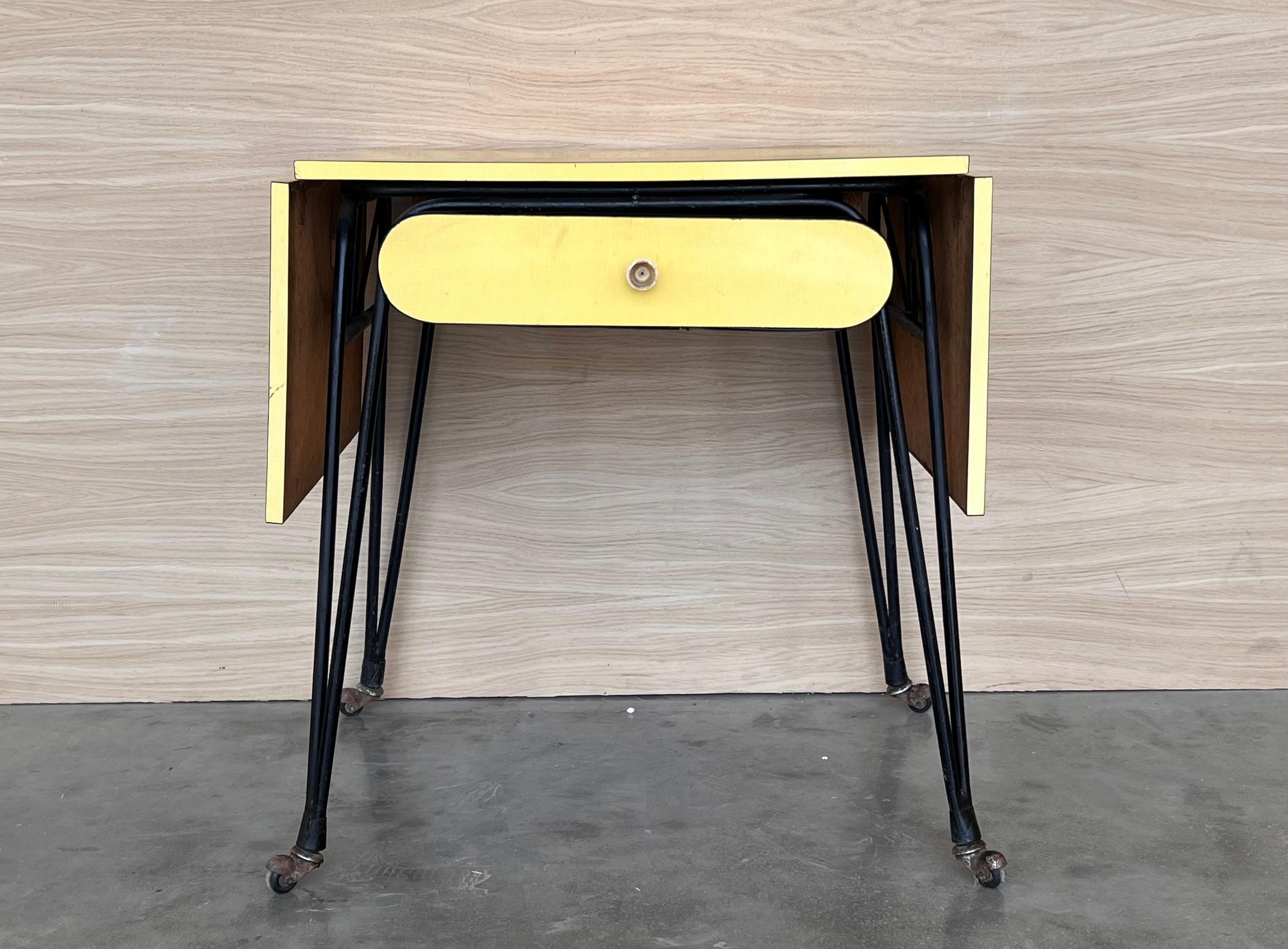 Yellow formica and black metal desk, Italian modernism, ca. 1960. Small desk from a hotel room with a matte black tubular metal frame and a rectangular-shaped top made of yellow Formica. 1960 ca. Perfect condition, fully restored with two leaves for