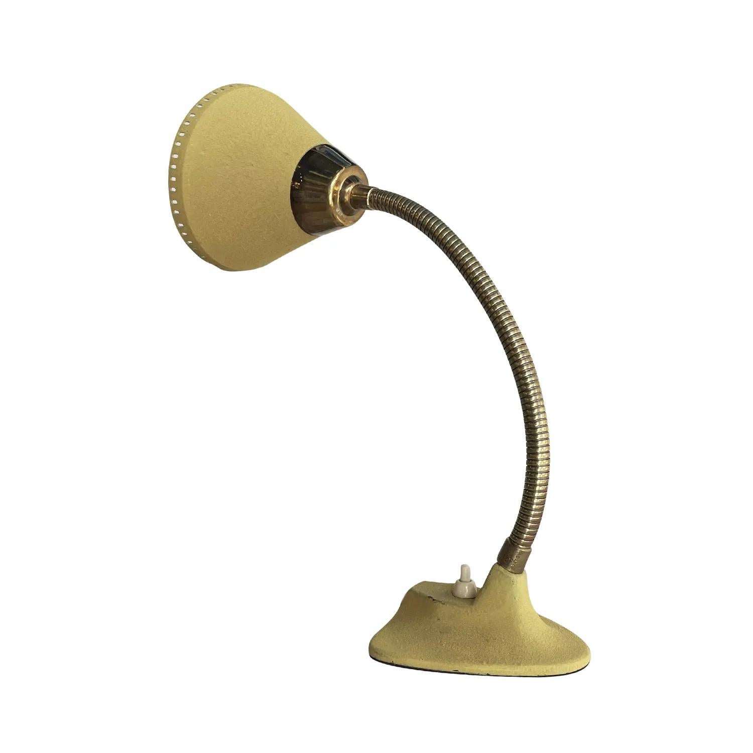 A small, yellow vintage Mid-Century Modern Swedish desk lamp made of hand crafted painted metal, produced by EWÅ, Värnamo in good condition. The Scandinavian table light is composed with a conical mount lacquered metal shade, supported by a