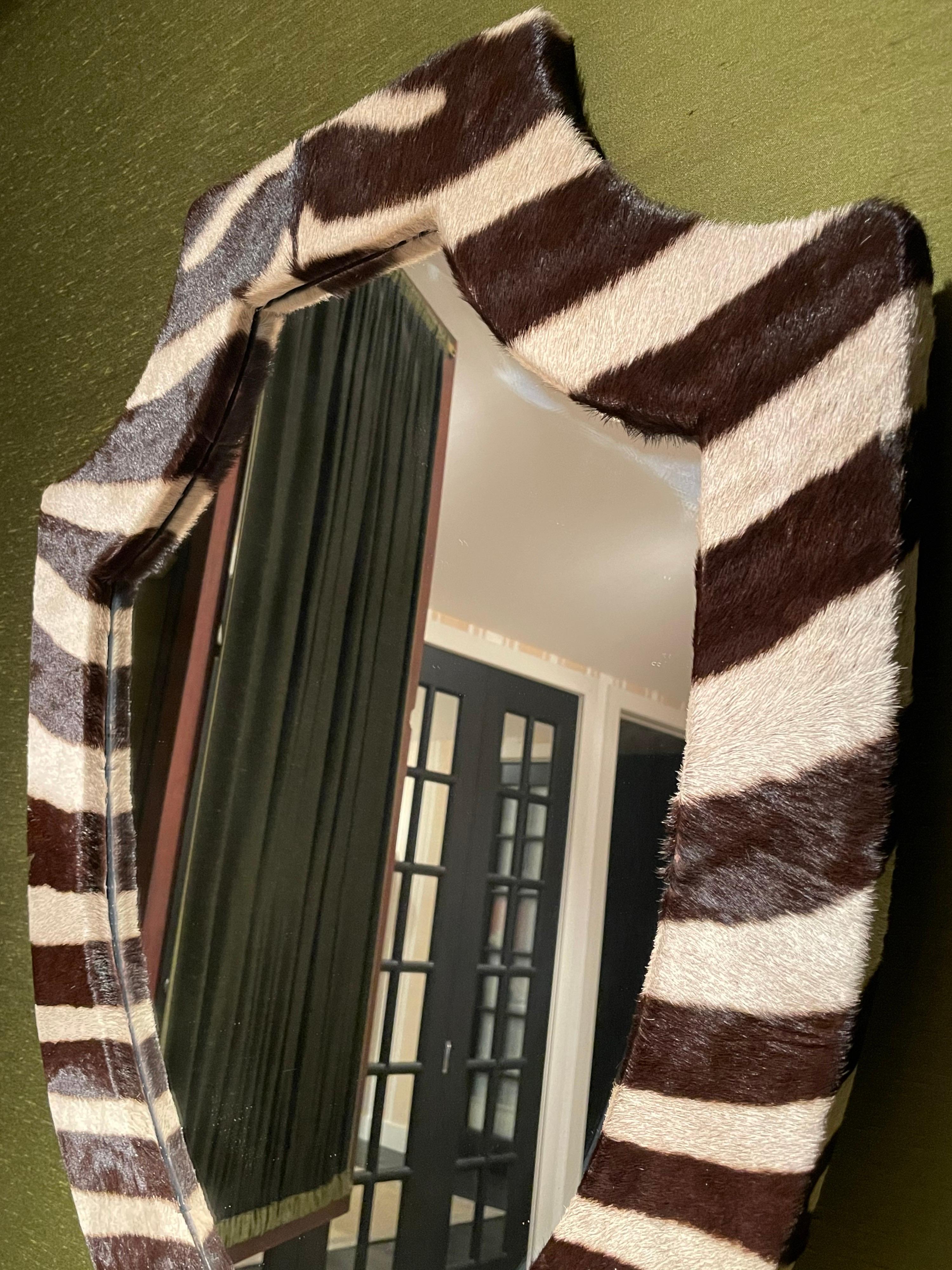 Beautiful genuine zebra hide mounted on a shield shaped mirror. The hide is in fantastic condition.