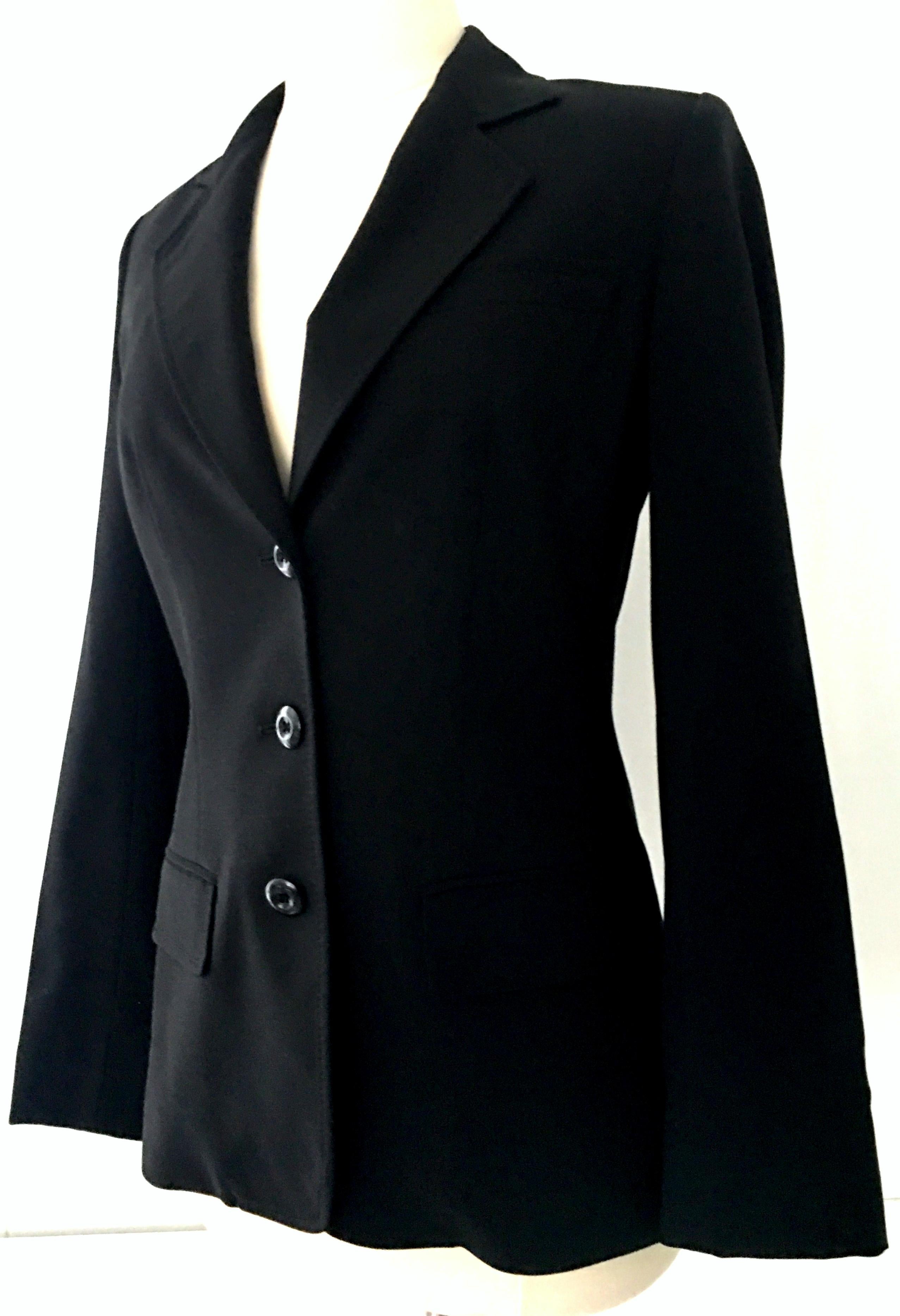 20th Century Christian Dior Paris Black Blazer Jacket-Size 6. This classic, timeless and well preserved wardrobe staple piece is executed in wool and polyester with beautiful stitching detail, three faux front pockets and three black 