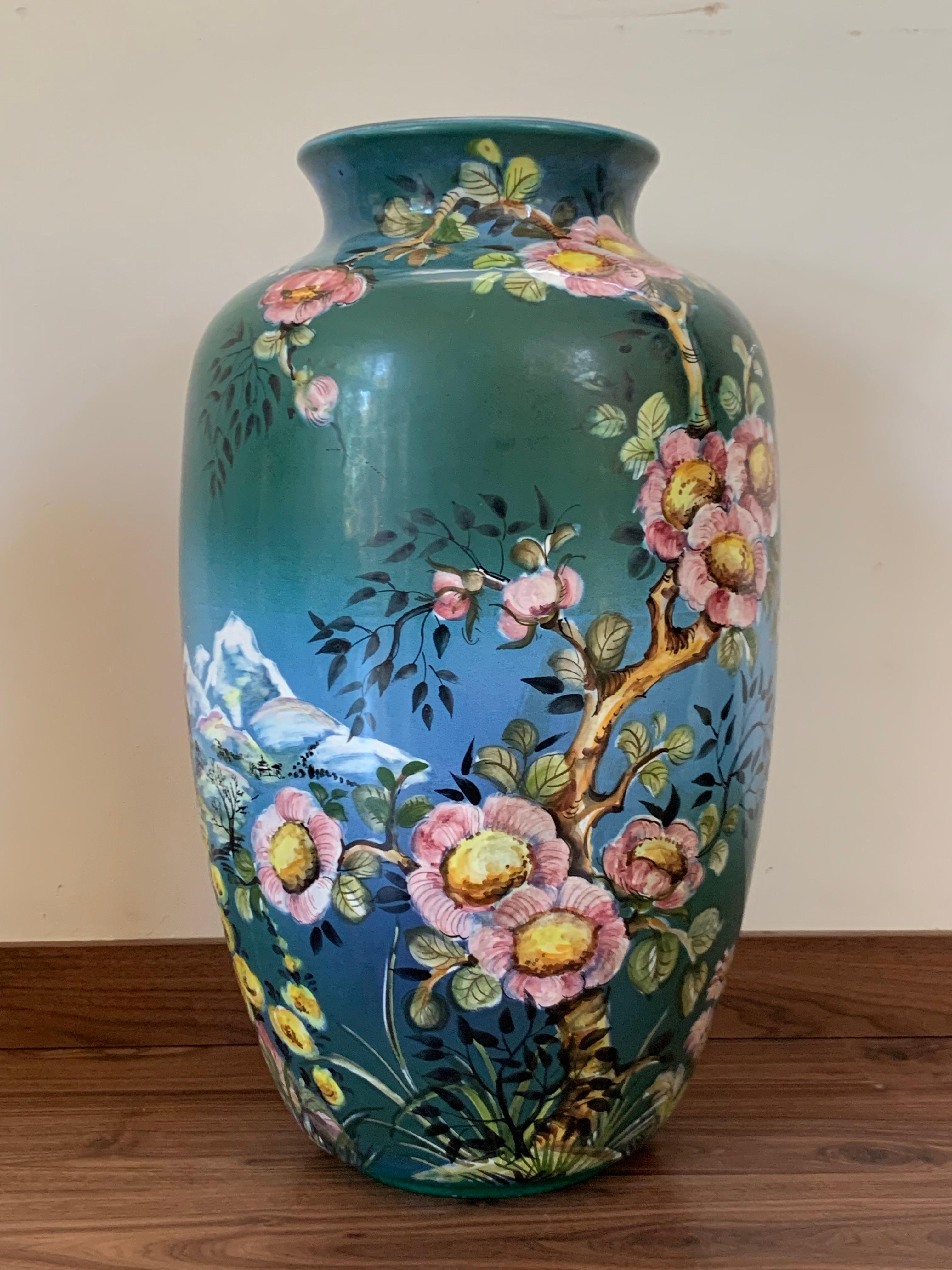 Featuring a painted chinesse scenes with exotic fruits, animals, ocean, and huts. The baluster vase was made by the German company Ulmer Keramik, which was established in Bohemia after World War II. The firm was known for a variety of traditional to