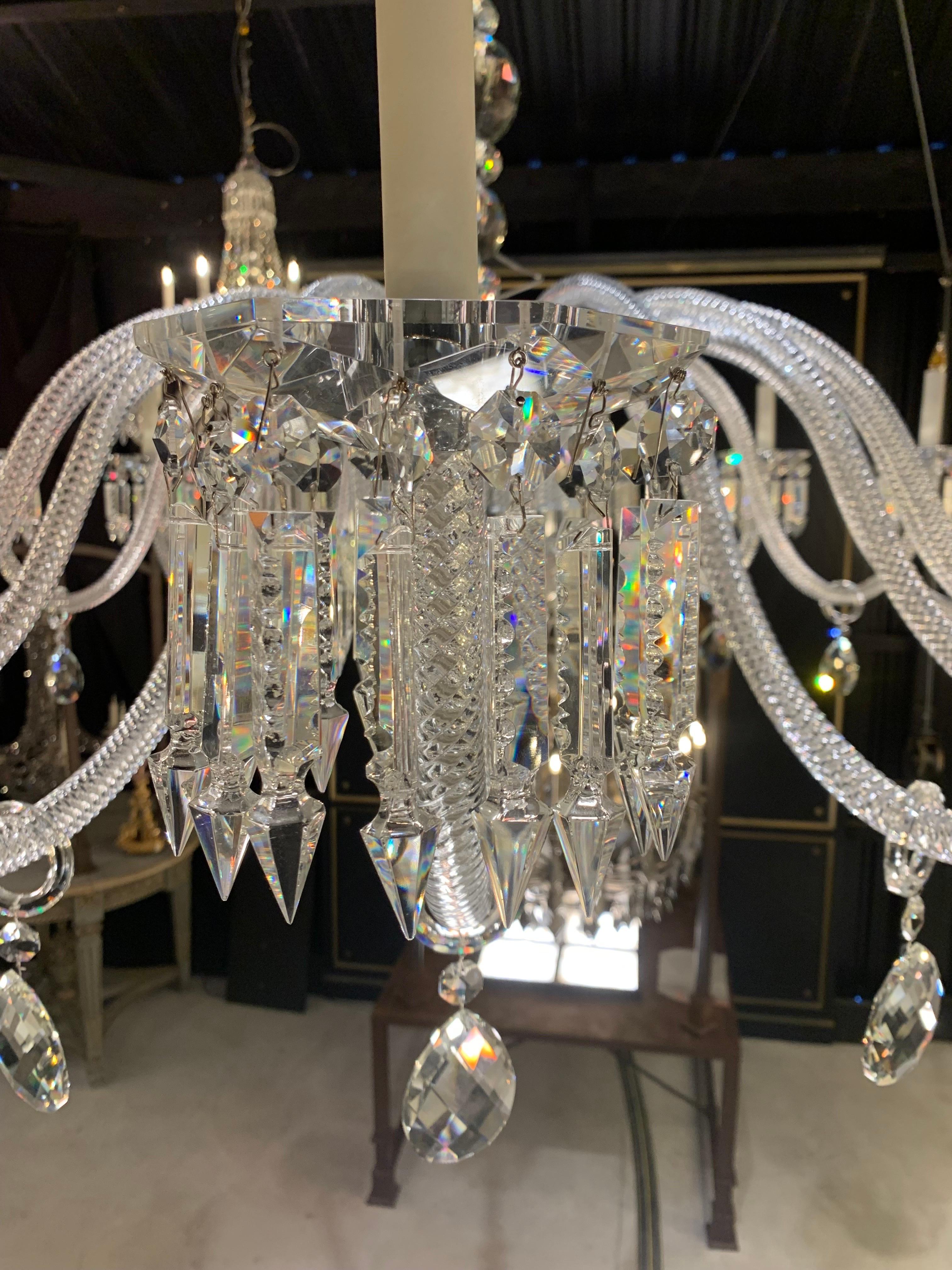 This chandelier is made of solid and hand cut crystal. 
The arms of lights are in twisted glasses. The central barrel is in chromed metal covered by crystal parts. 

We have one chandelier in stock however we can produce them made to measure and
