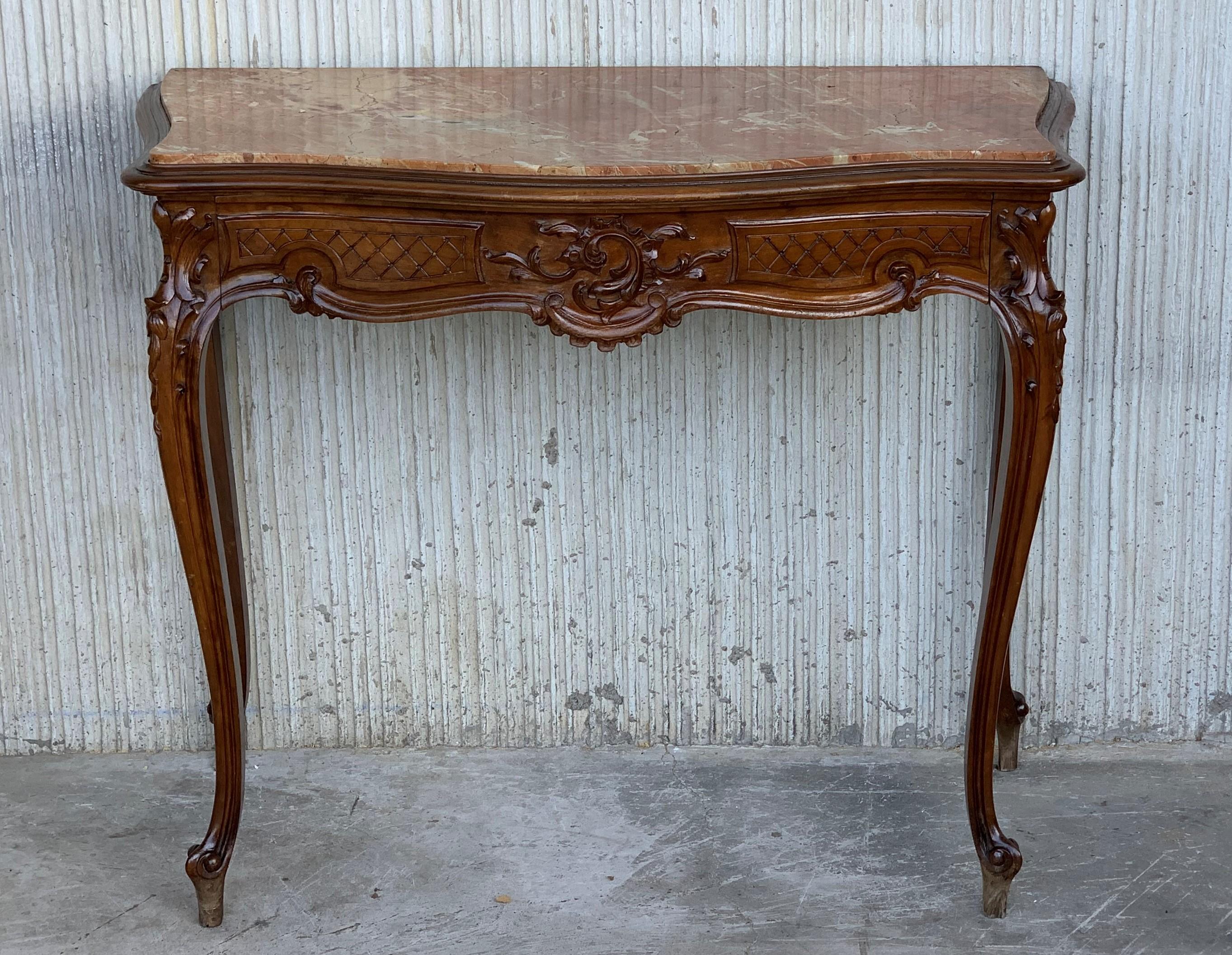 Walnut console table with four curved legs with a drawer and a marble top.
    