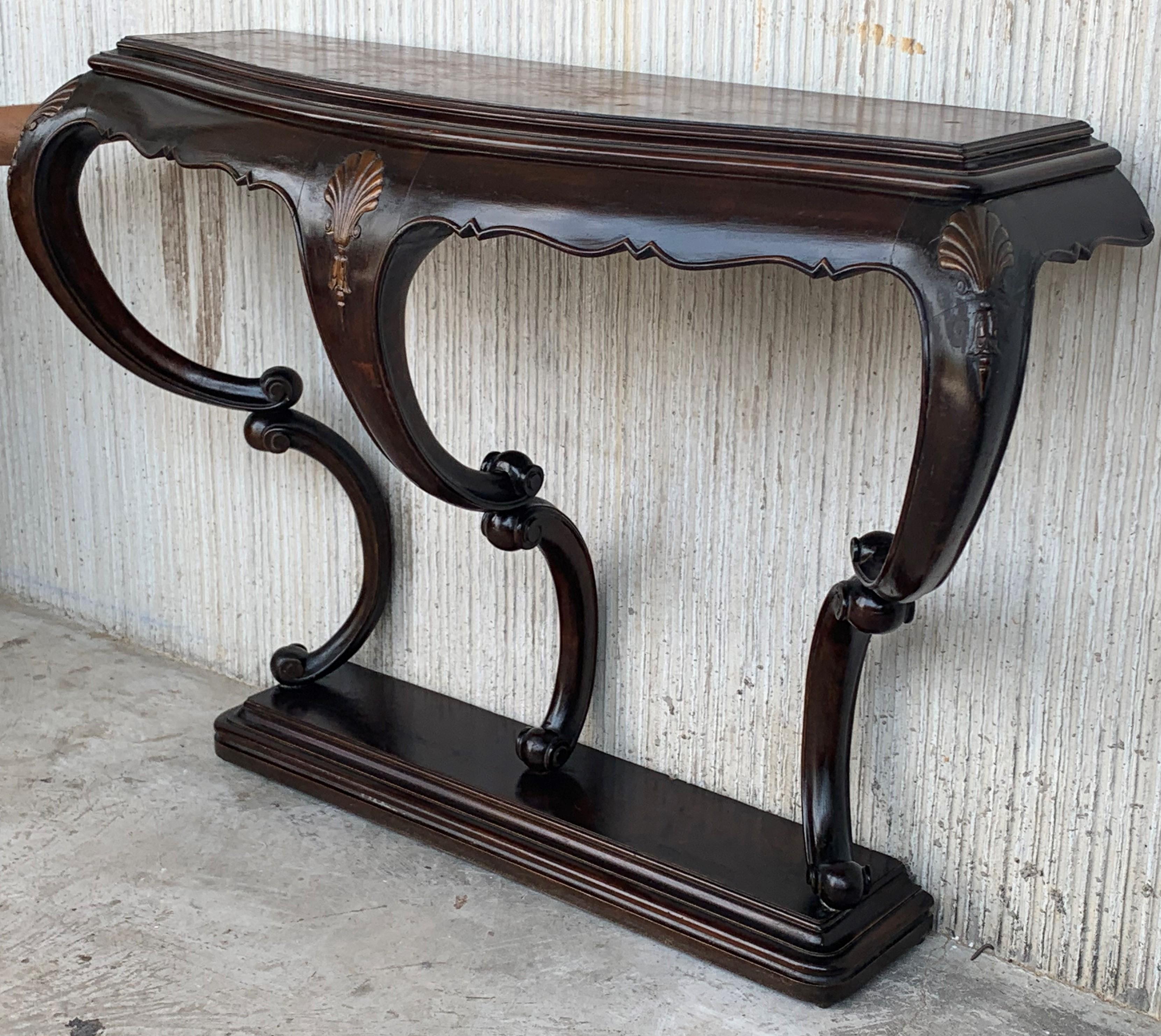 Walnut console table with four curved legs with a drawer and a marble top.

You must to fix to the wall.

  