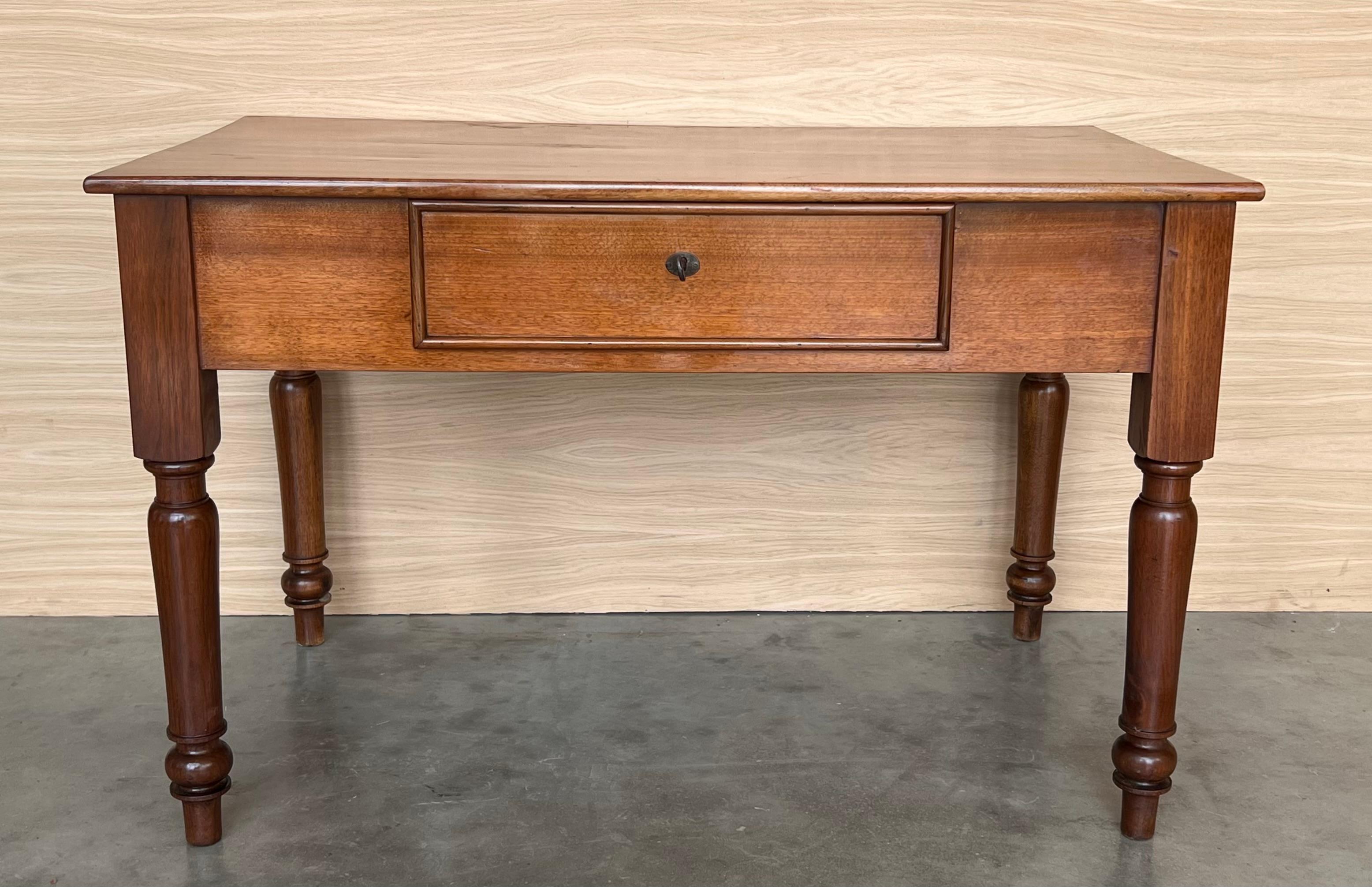 This elegant fruitwood desk was created in France, circa 1920. Made of blond walnut timber, the large writing table sits on four  legs The front has a wide opening with plenty of knee space and the back is embellished perfectly finished. The writing