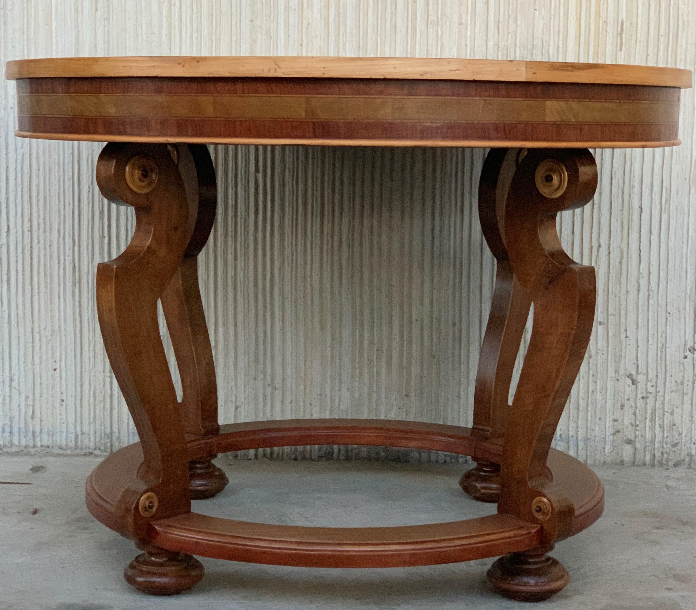 20th marquetry round center table with four cabriole legs.