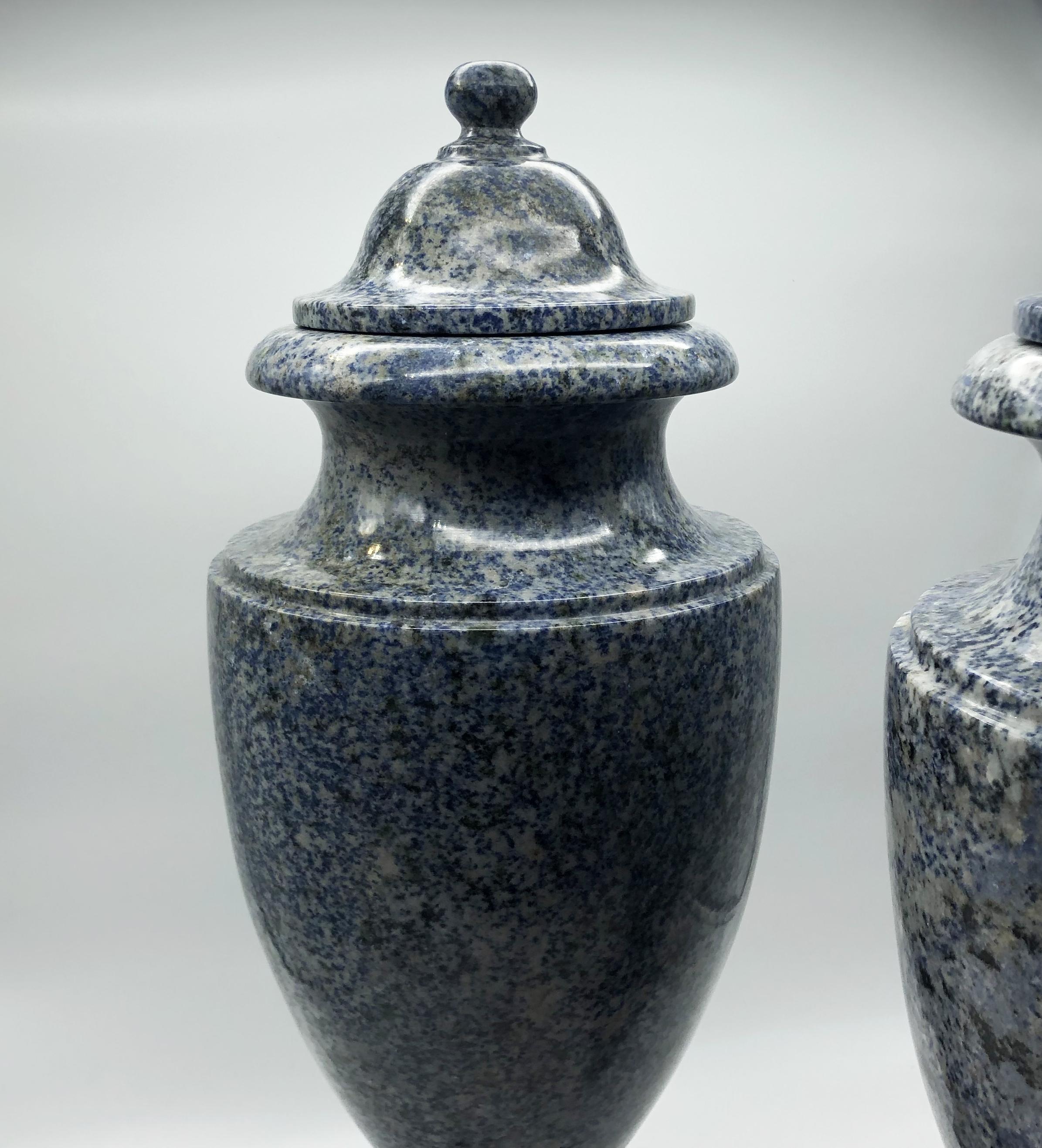 An impressive pair of blue Italian neoclassical vases made in one of the most beautiful stone the Azul Baiha, similar and strong than granite but with a small different of the colour that is unique, and black and gray and white point inside. The