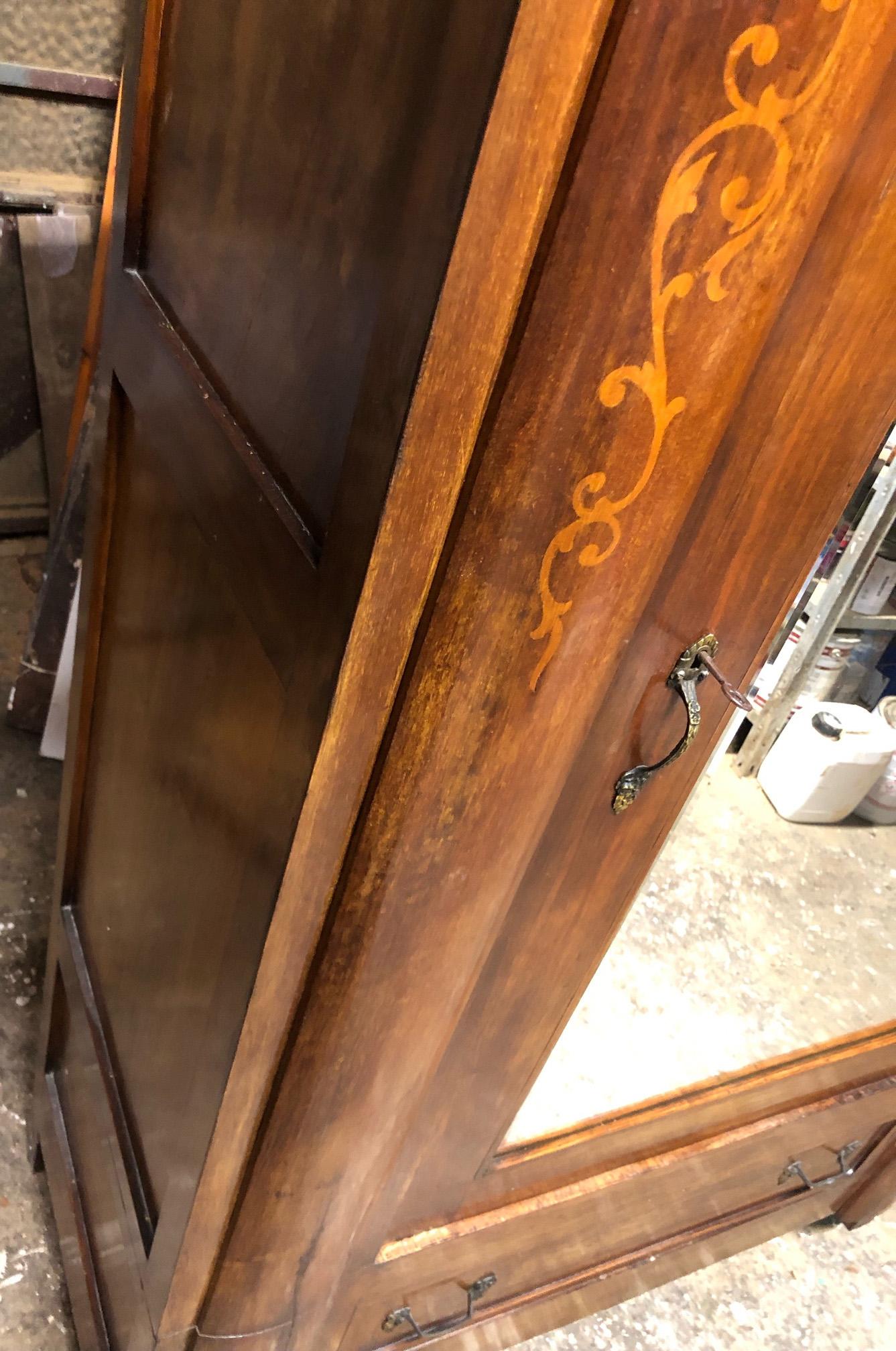 20th Italian wardrobe in inlaid walnut with original mirror on door.
Inside it has a shelf and a clothes rail.
Inlays made by hand.
Original handles. 
All parts and locks are functional. 
Among my articles belonging to the same house, I have