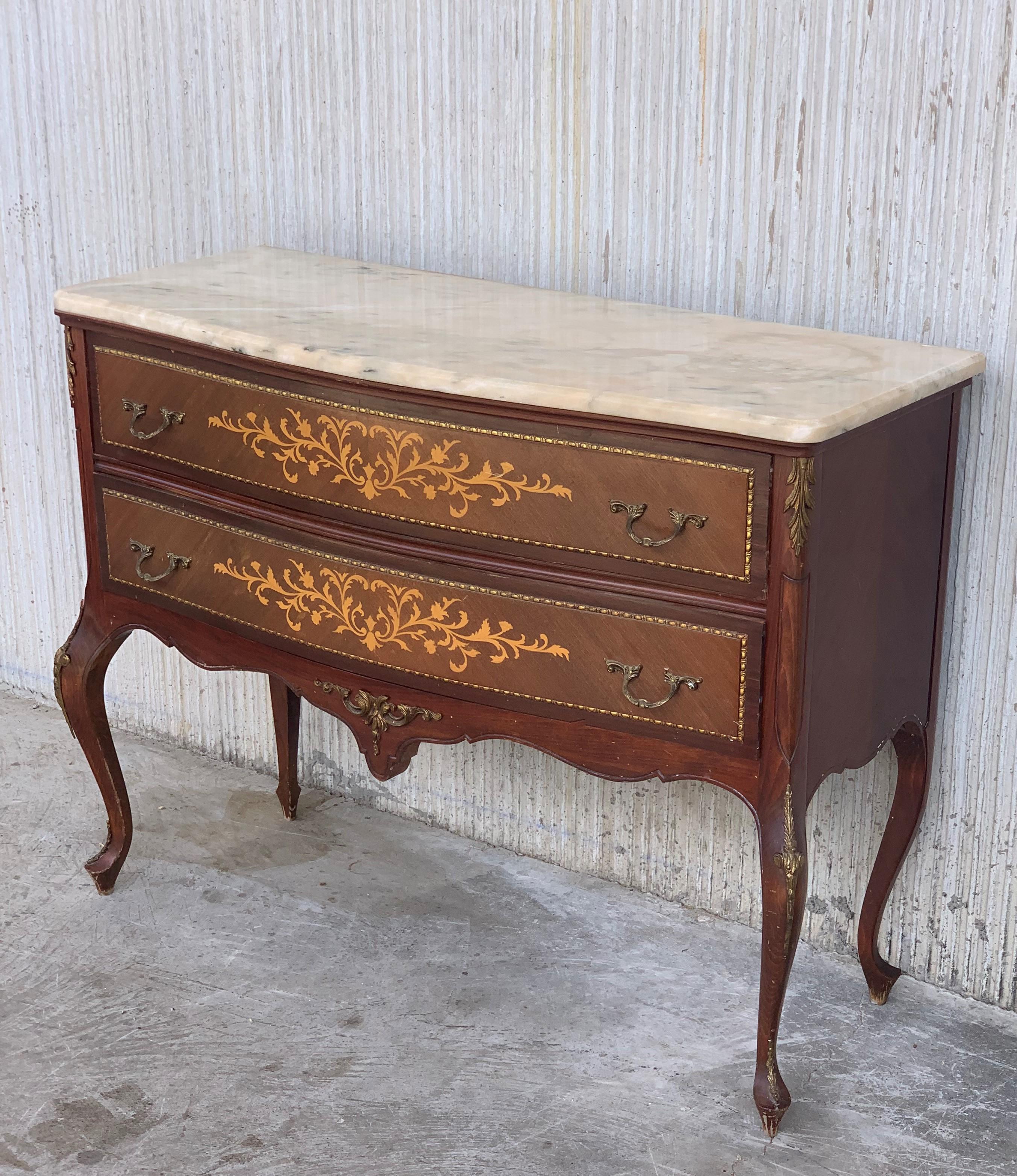 20th century marquetry chest of drawers with bronze details and cream marble top.