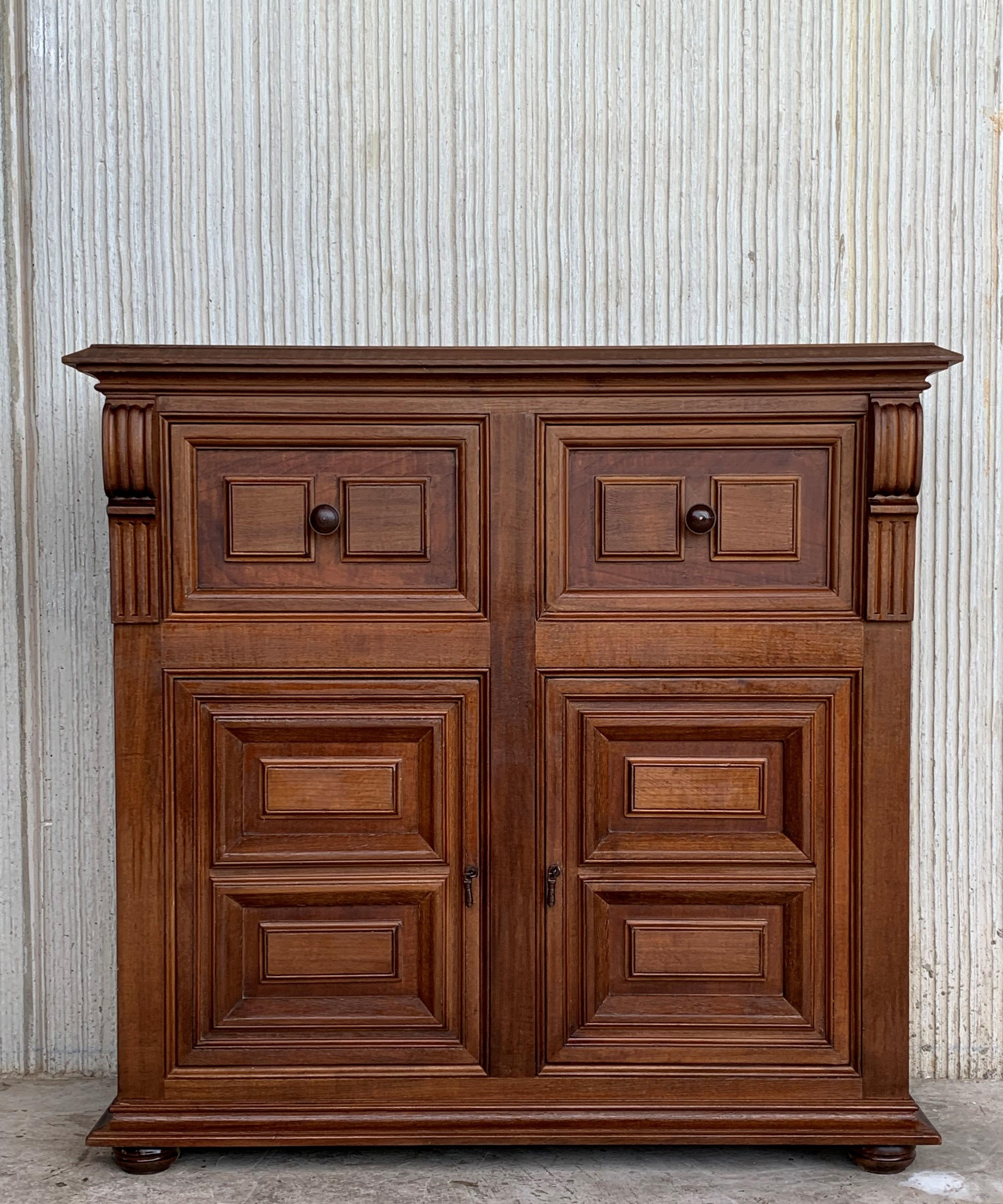 From Northern Spain, constructed of solid walnut, the rectangular top with molded edge atop a conforming case housing two drawers over two doors, the doors paneled with solid walnut, raised on a plinth base.
Very solid and heavy buffet.

 