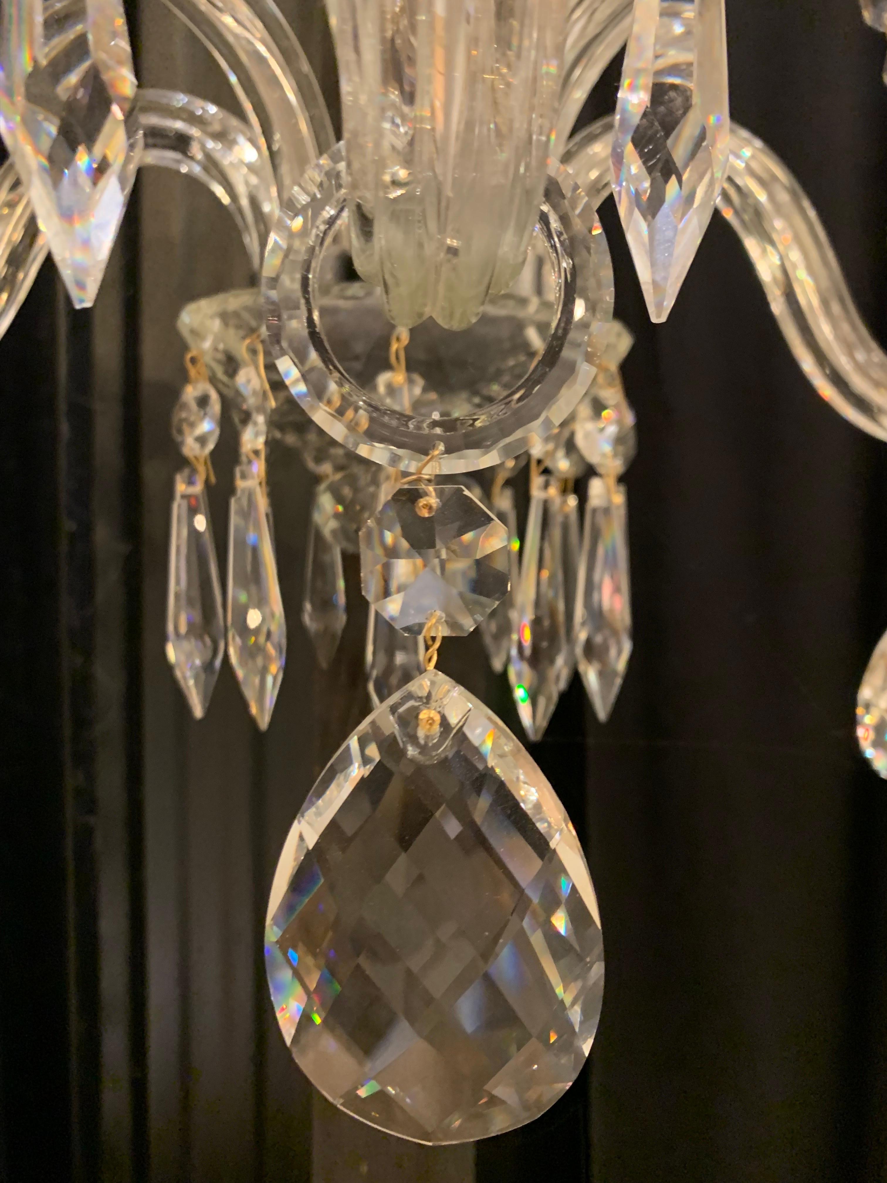 This pair of crystal wall lamp with 5 lights is made of solid and hand cut crystal. 
The central barrel is in silver metal covered by crystal parts.

We have one pair of this wall lamp in stock however we can produce them made to measure and in