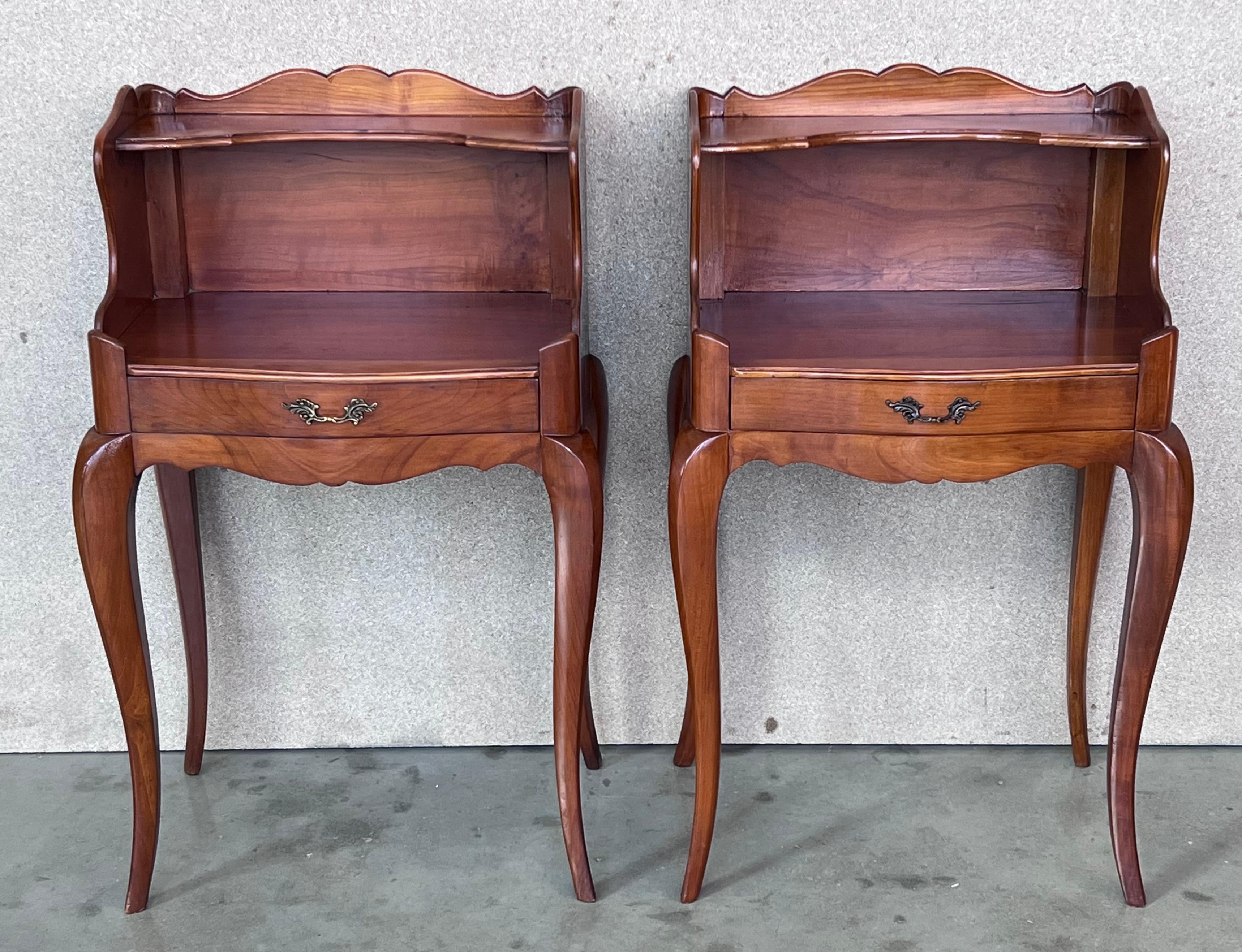 A pretty pair of French one drawer nightstands with open shelf , circa 1910.
Pair of French Louis XV style walnut bedside tables from the early 20th century. This pair of French 'tables de chevet' was created in the early years of the 20th century,