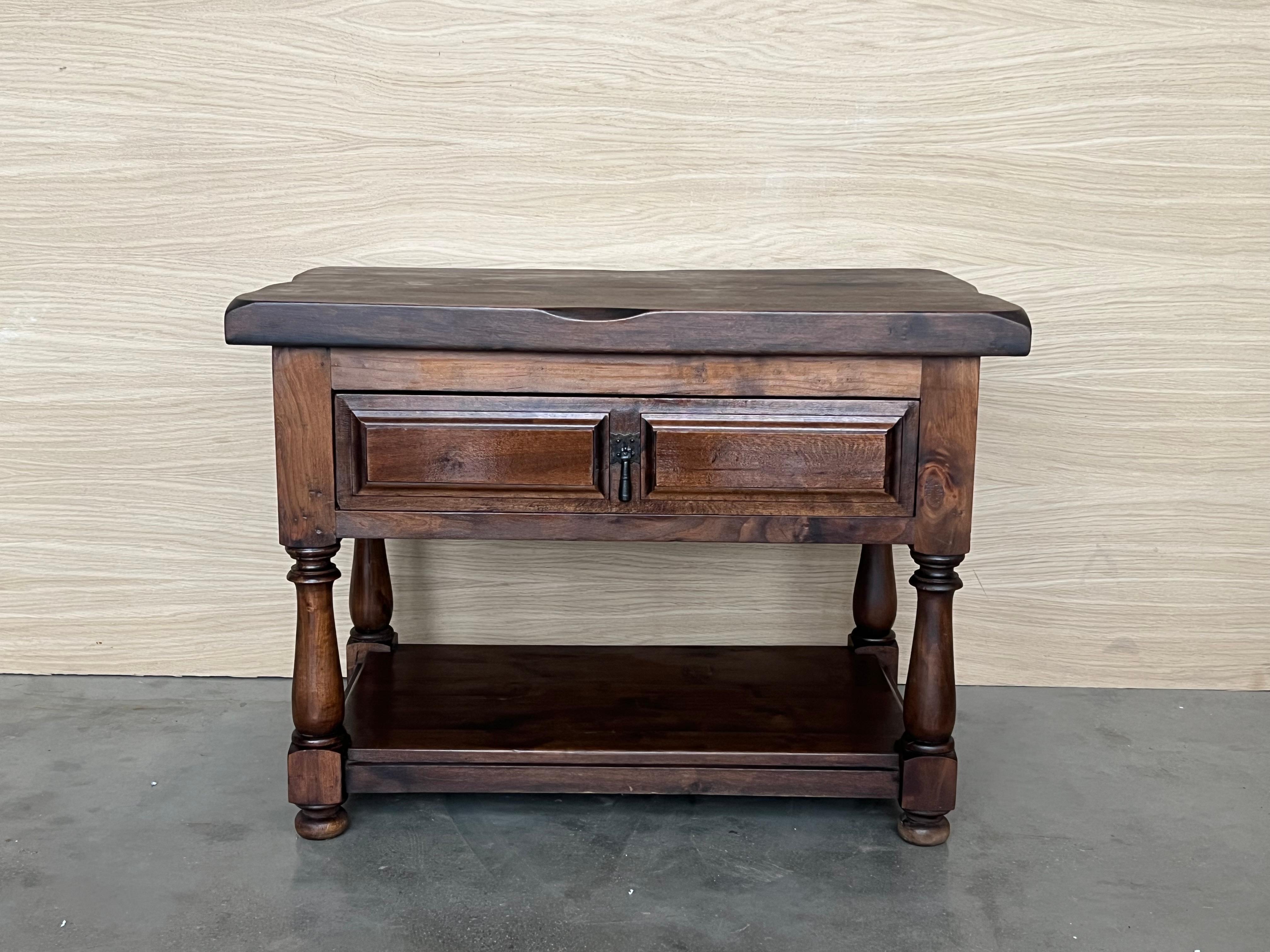 20th century Pair of Spanish nightstands or large low tables with one drawer , iron hardware and low shelve. The table has beautiful carved drawers with original iron pull and really nice patina.
 Beautiful tables that you can use like a nightstands