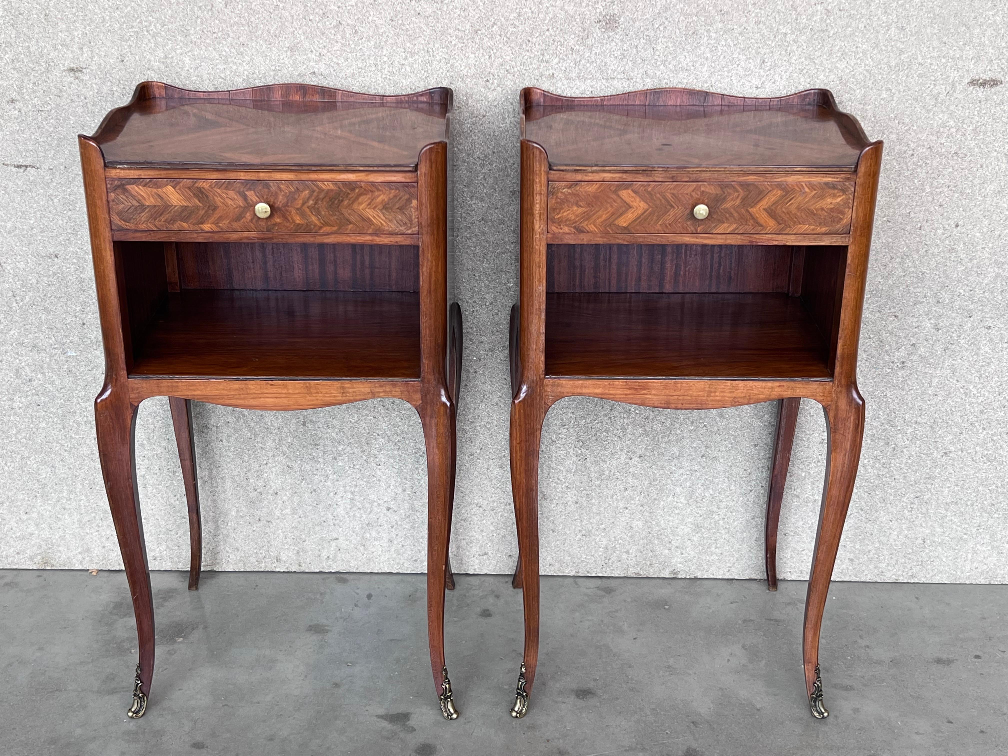 A pretty pair of French, inlaid kingwood, one drawer nightstands with open shelf , circa 1910.
Pair of French Louis XV style walnut bedside tables from the early 20th century. This pair of French 'tables de chevet' was created in the early years of