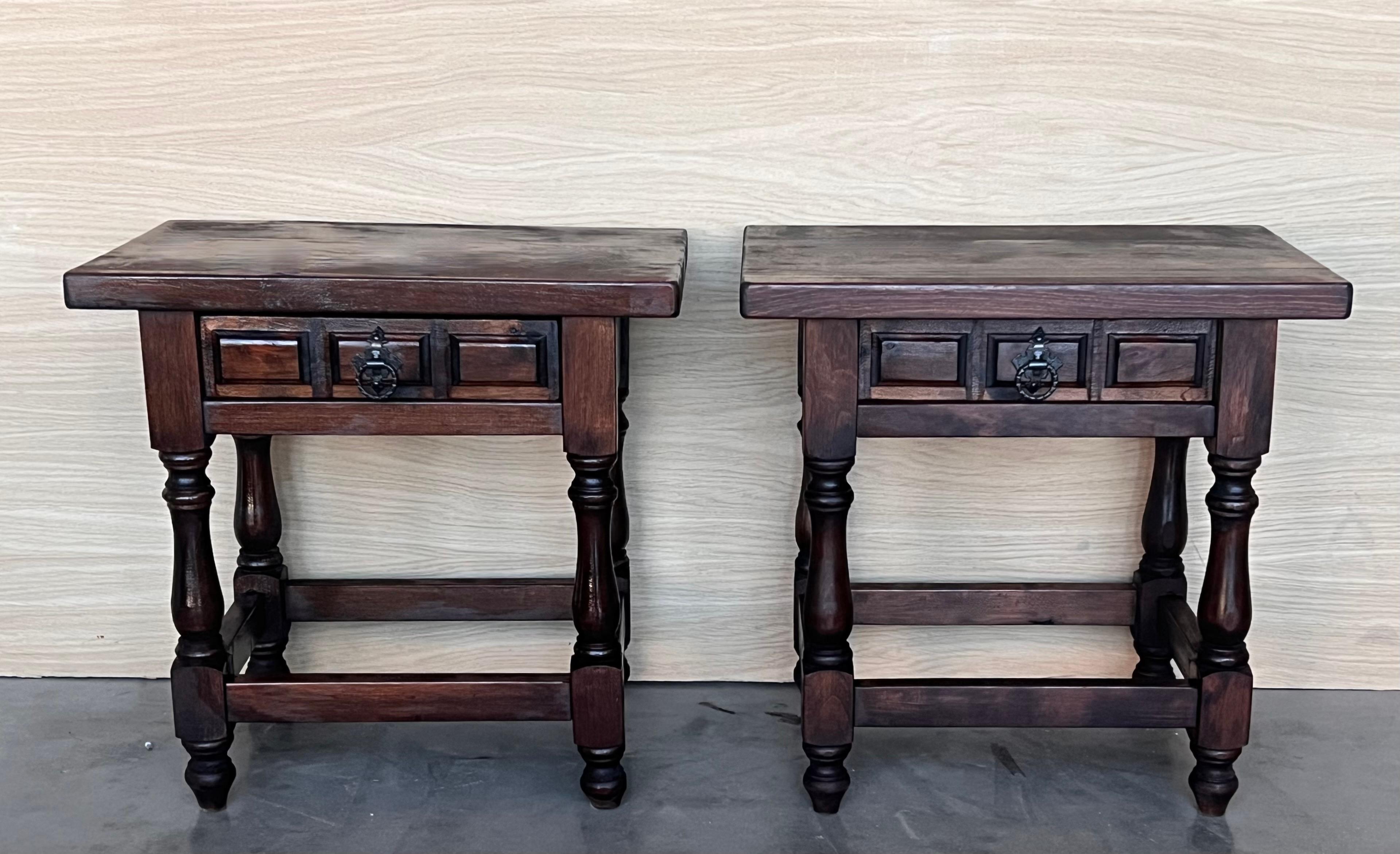 20th century Pair of Spanish nightstands with one drawer and iron hardware. The table has beautiful carved drawers with original iron pull. Beautiful tables that you can use like a nightstands or side tables, end tables or table lamp, desk or