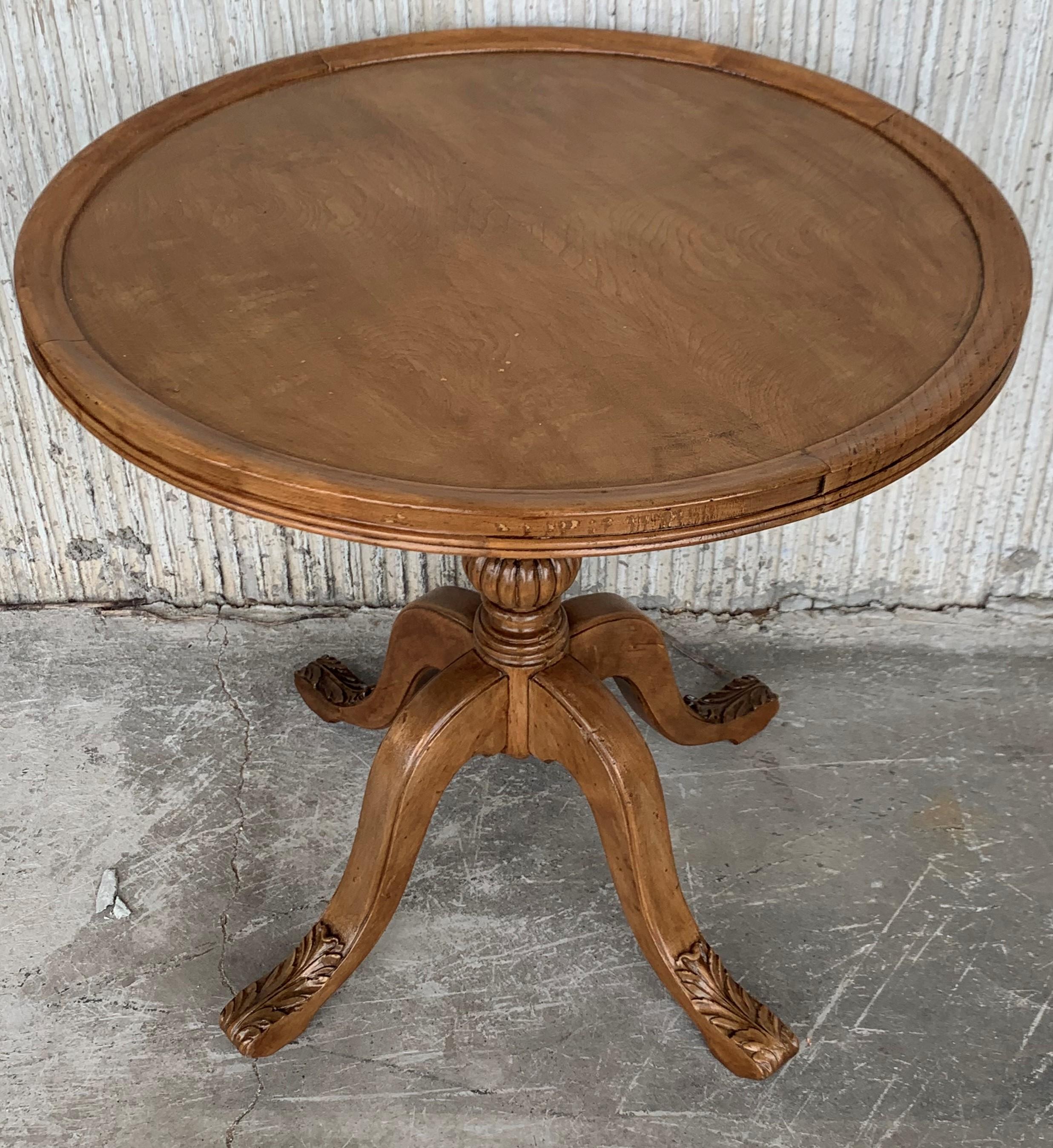 20th century English pedestal walnut round coffee or side table with ornamental carved legs.