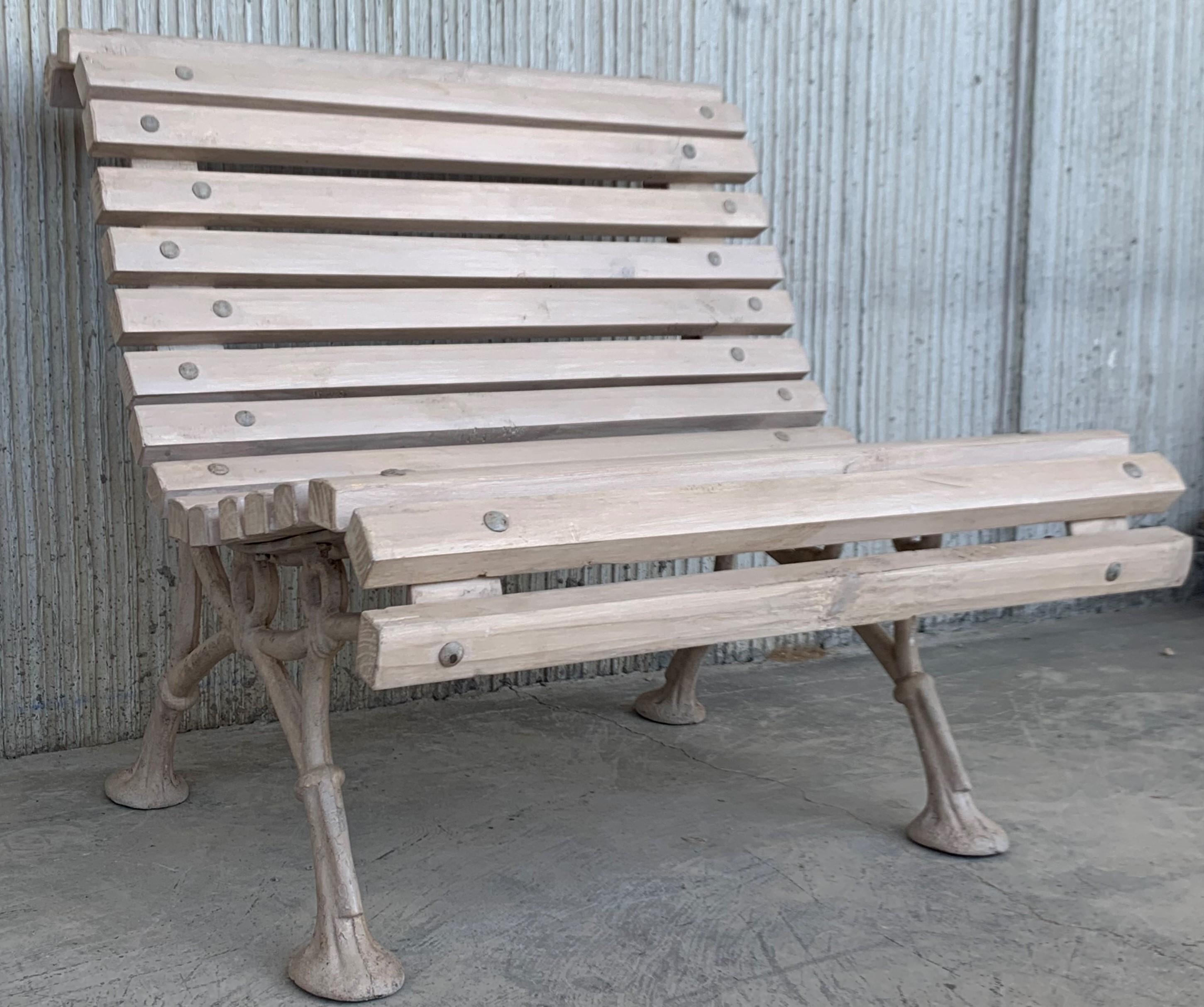 Beautiful old park bench, circa 1900 (Düsseldorfer Hofgarten) with cast iron feet. In the turmoil of the Second World War, the wooden strips of park benches in Germany were partly used as firewood. After the war, these wooden strips were replaced to