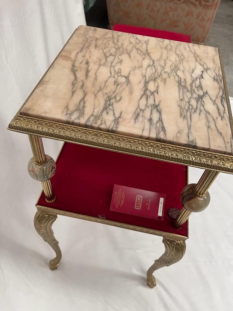 A item created by brass, white marble and a wonderful red velvet. It's a raffined confortable sofa. Its spheres details are made by glass and crystal.