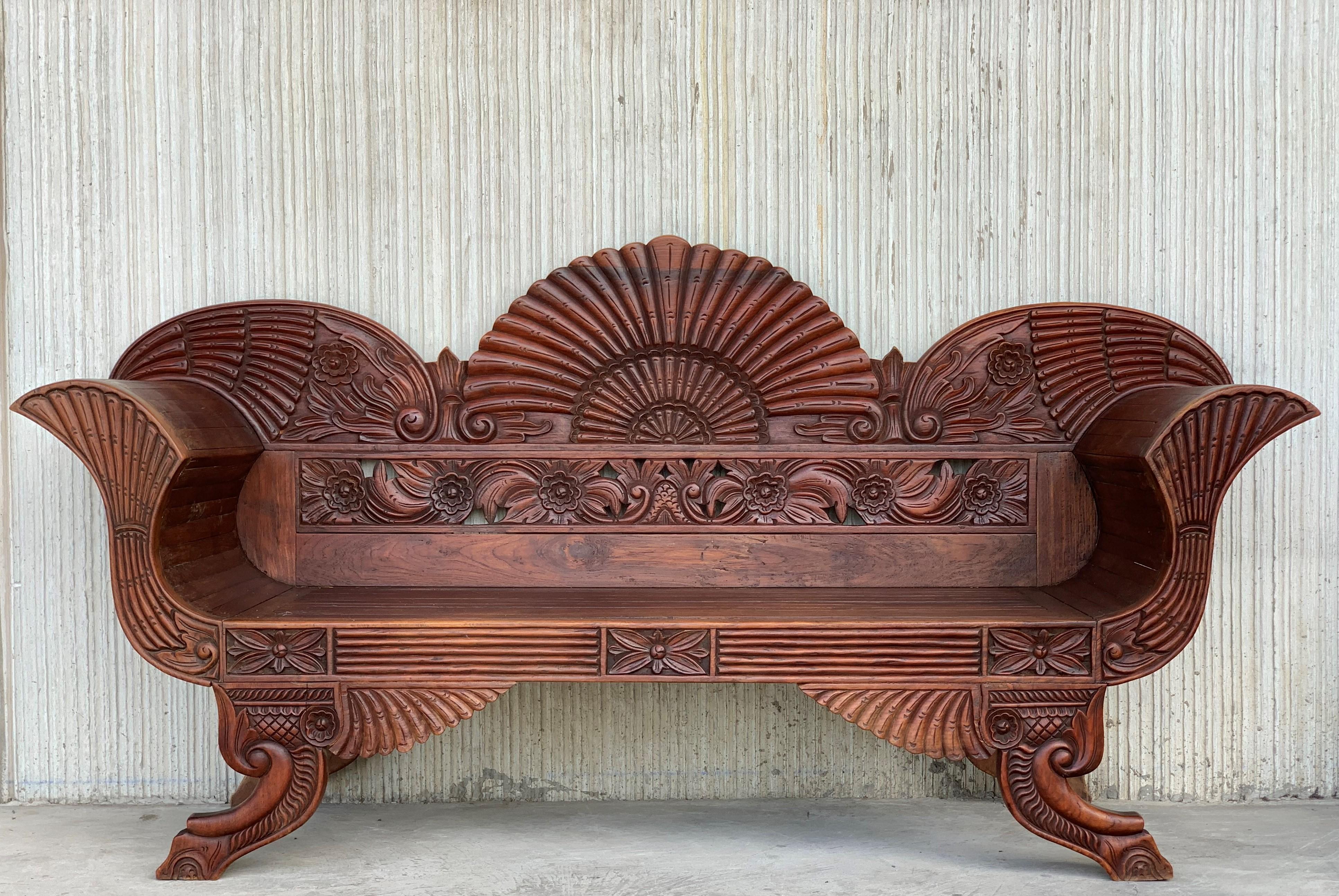 20th century Spanish carved back garden bench or settee with curved arms.
     

  