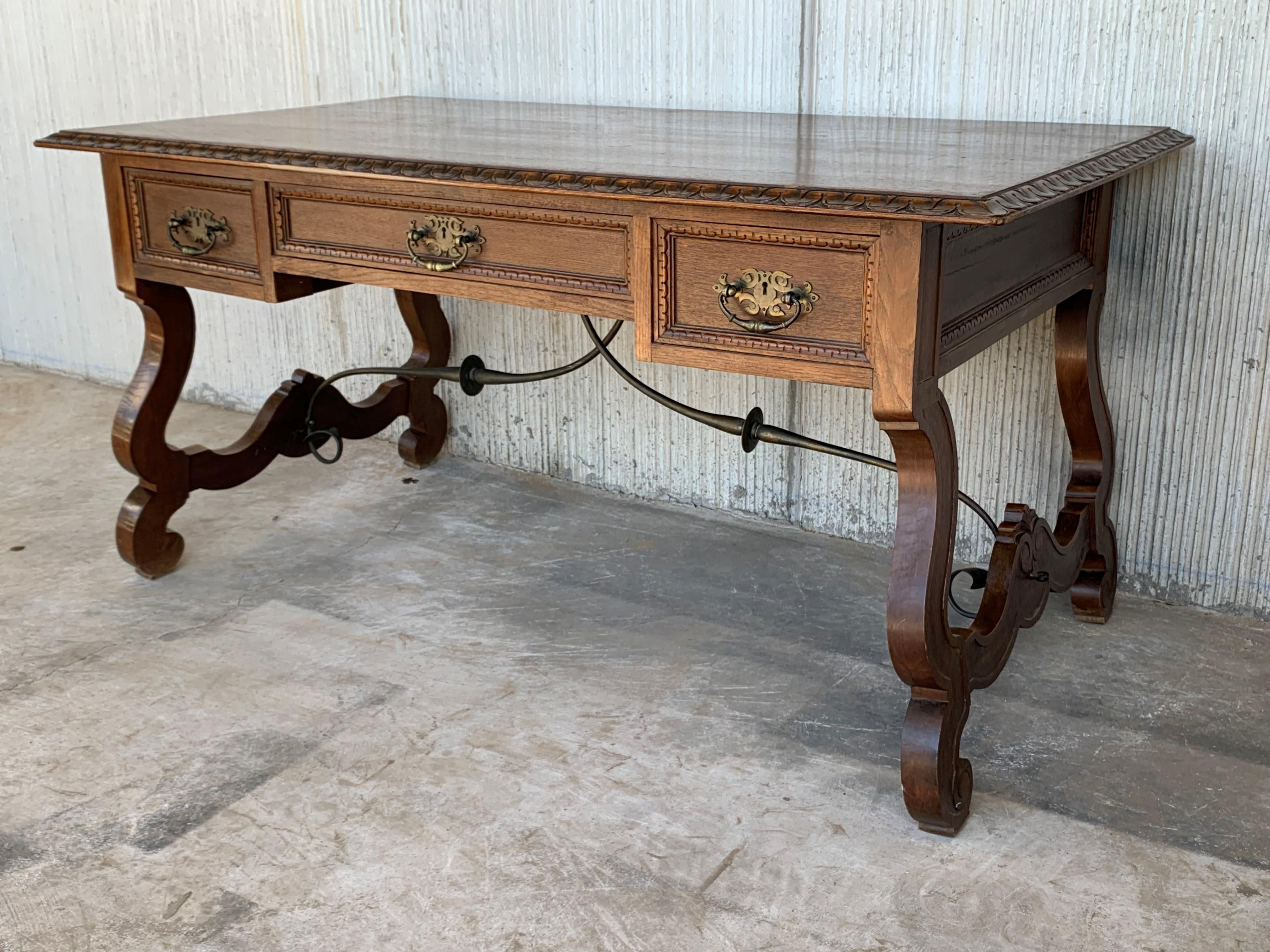 20th Spanish desk or library carved oak table with three drawers, Lyre legs and iron stretcher.
It has a glass top included as you can see in the pictures.