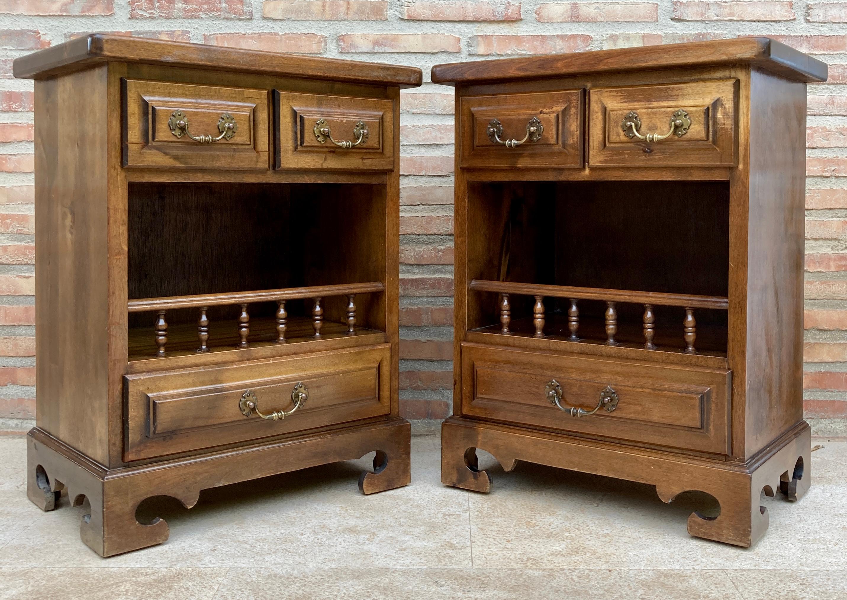 Pair of 20th century Spanish bedside tables with two small drawers, an open shelf with a pilaster railing and a low drawer with bronze fittings. 
Beautiful tables that you can use as bedside tables or side tables or lamp table.