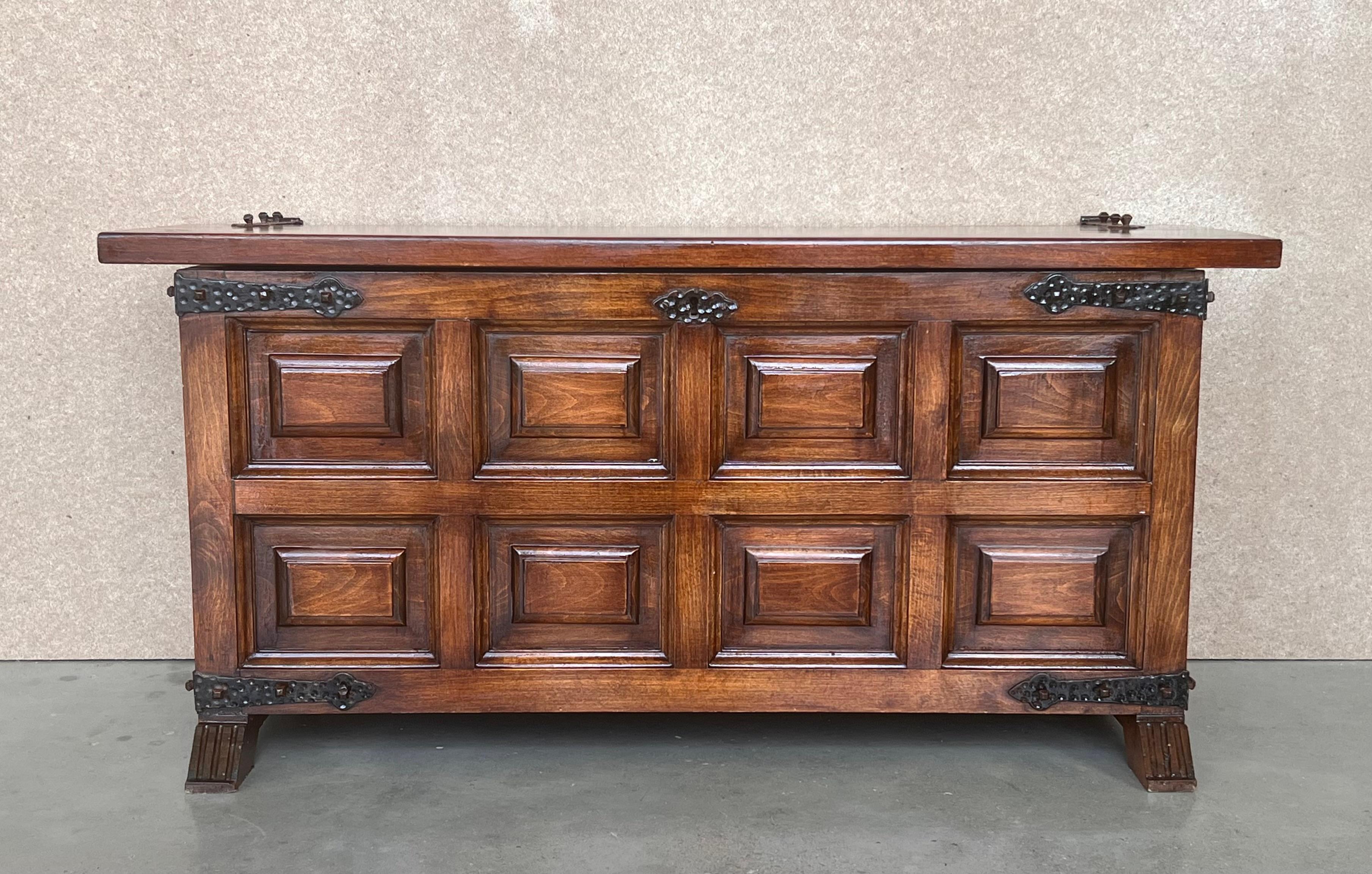 20th Spanish trunk with raised wooden panels and original iron hardware

A Spanish carved wood blanket chest from the 20th century. This antique trunk from Spain features a wood case heavily carved in geometric patterns. This wooden chest has a