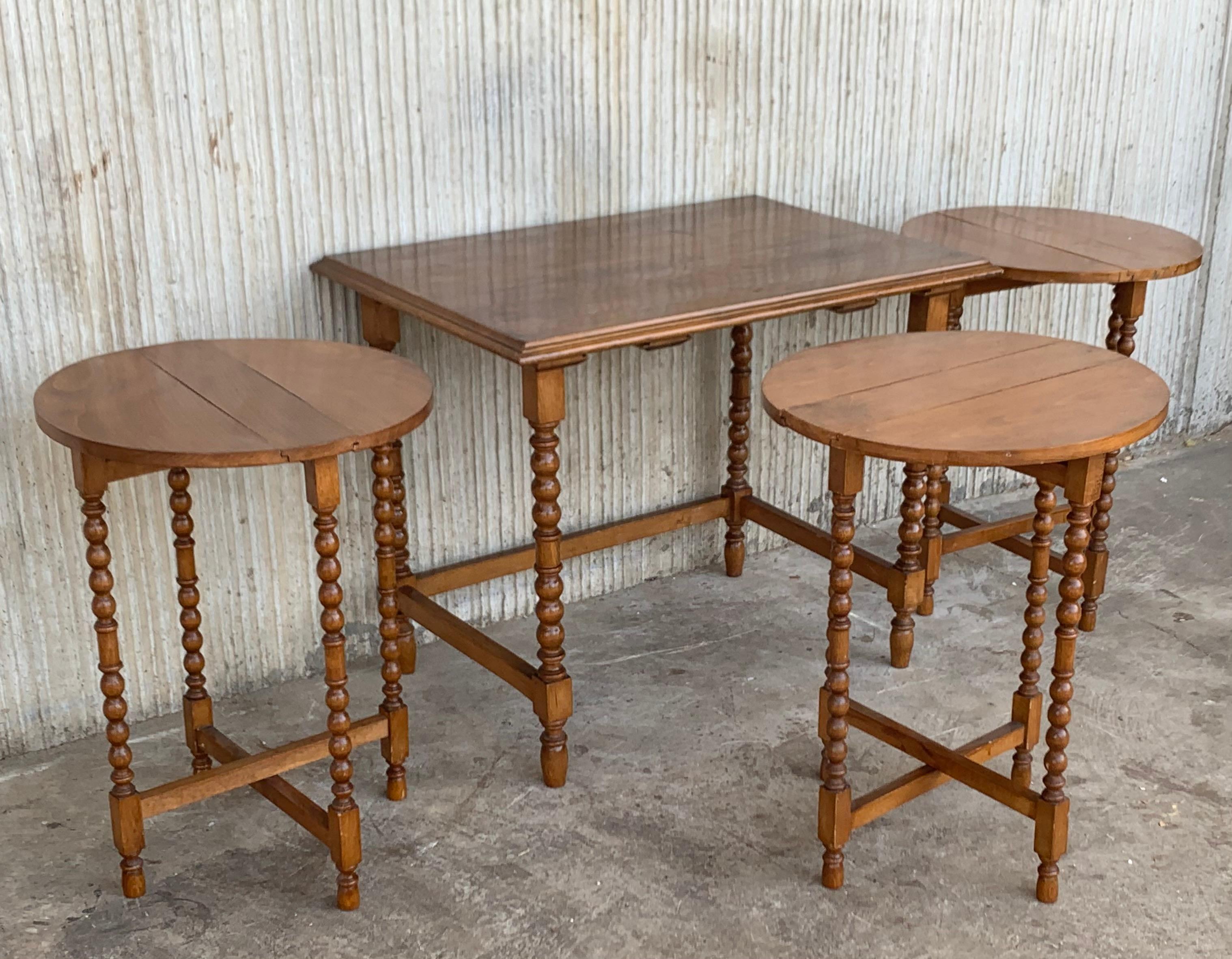 20th Spanish walnut nesting tables with turned legs

Carved and turned side tables. The set has a rectangular table with three round side and folding tables

Each round table is 15.55in diameter.
