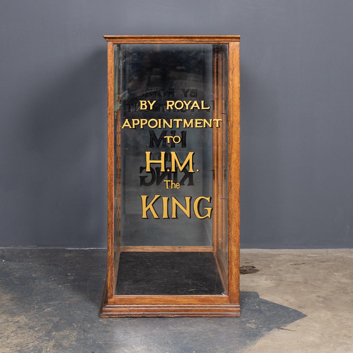 Antique early-20th century English glass & mahogany shop display cabinet with brass edges on a wooden stand. A small counter top display cabinet is later sign written for the famous Hardy Brothers angling specialists with rear access and two glass