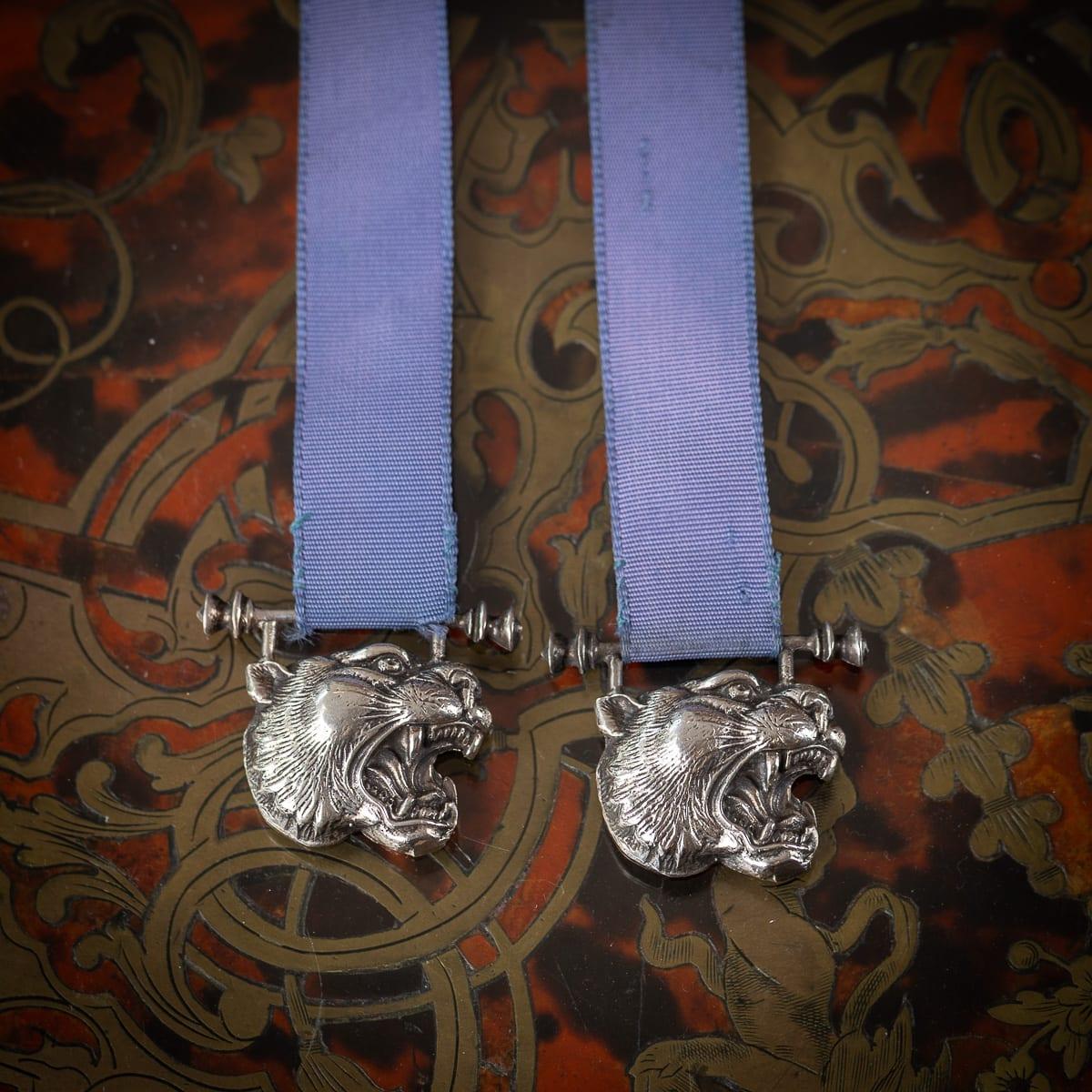 A vintage 20th Century English solid silver and blue silk bookmark. Either end of the silk ribbon are two tiger faces with teeth showing. Hallmarked English solid silver (925 standard), Birmingham, year 1987 (N), Maker's mark KS (Kate Shea).