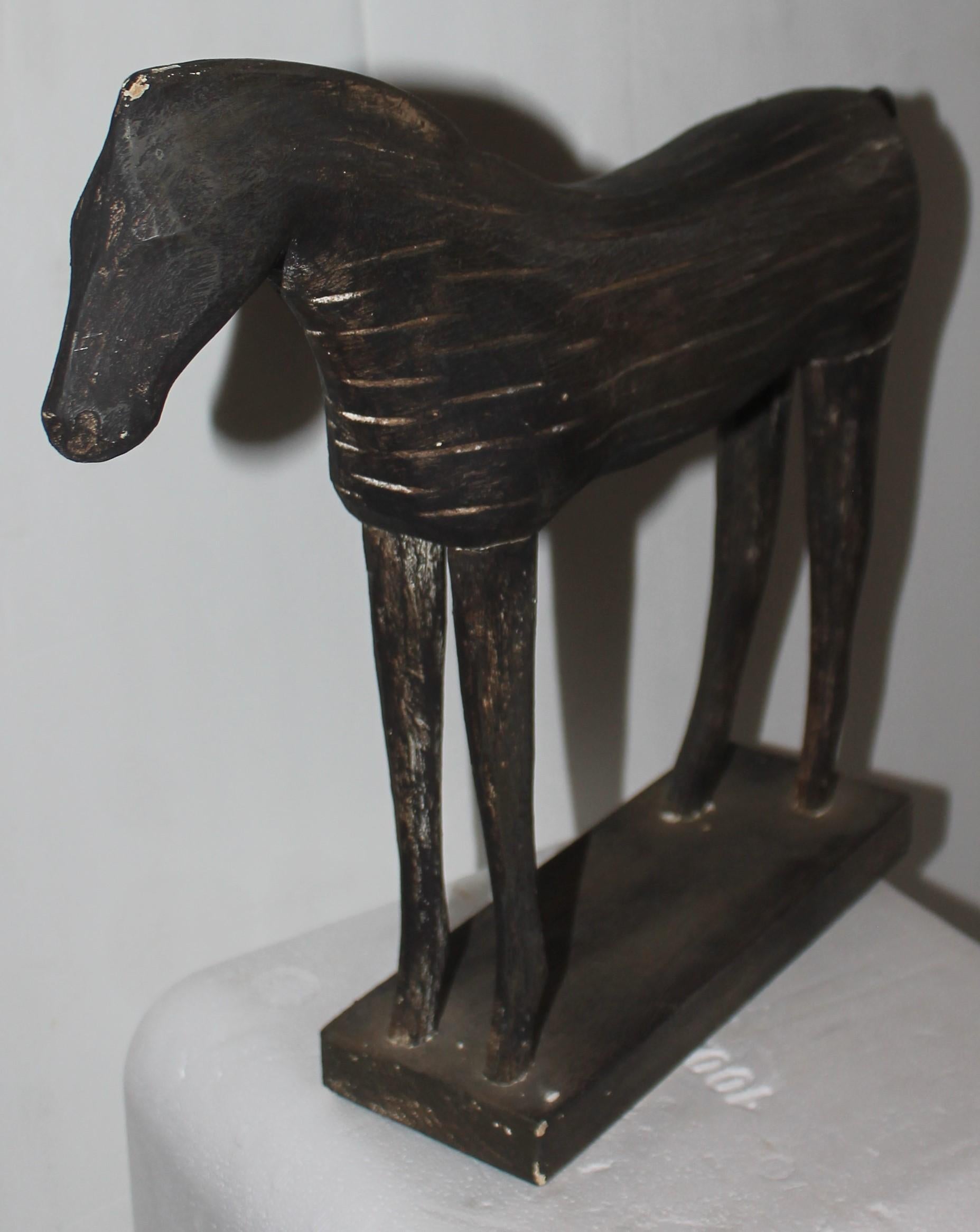 This fun & folky 20thc hand carved and painted horse is carved out of wood. It has a wonderful aged patina but is a later version of a earlier horse.