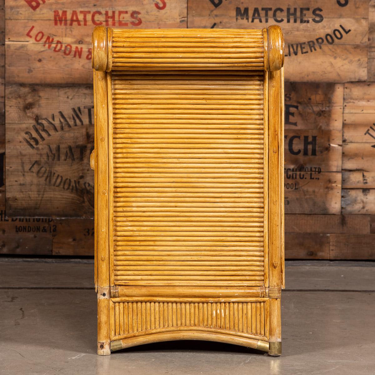 French 20th century very stylish and large bamboo sideboard, with scrolled detail at either end, brass capped feet and is lined with melamine for extra durability. Fronted by two sets of doors opening up to large storage areas with shelves and