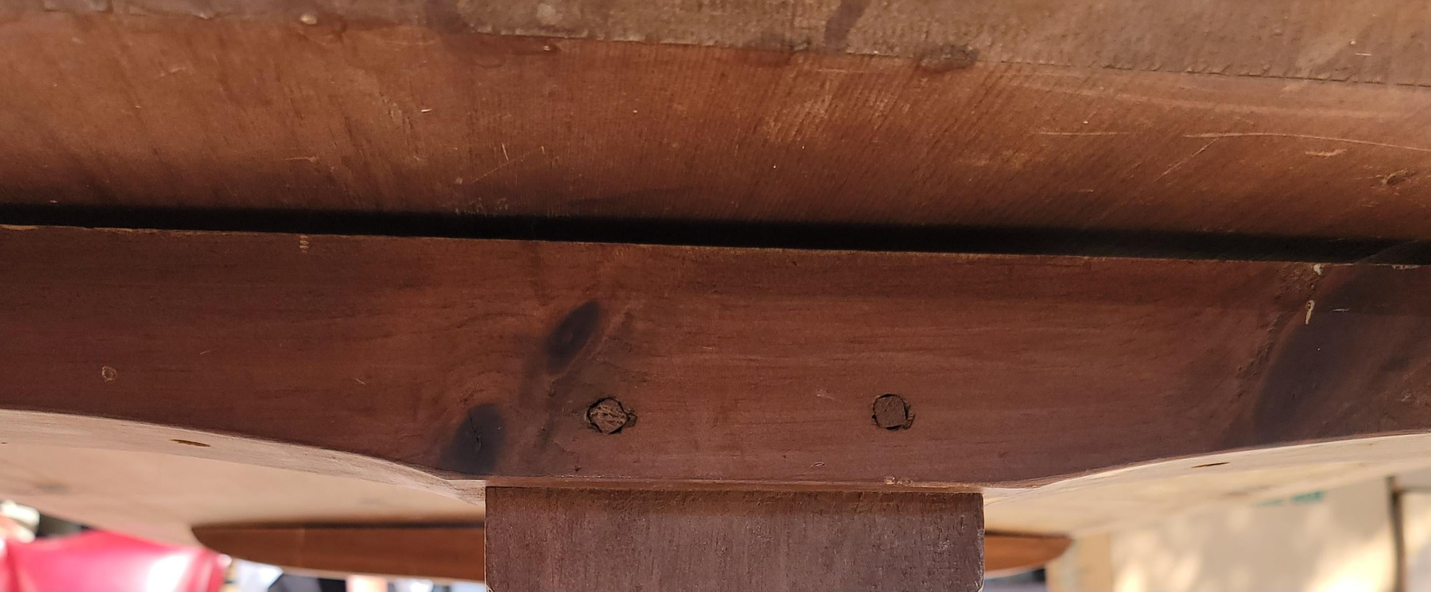 Early 20thc pine trestle table from Pennsylvania with red painted base.The top has a wonderful aged patina.The table is in fine sturdy condition.