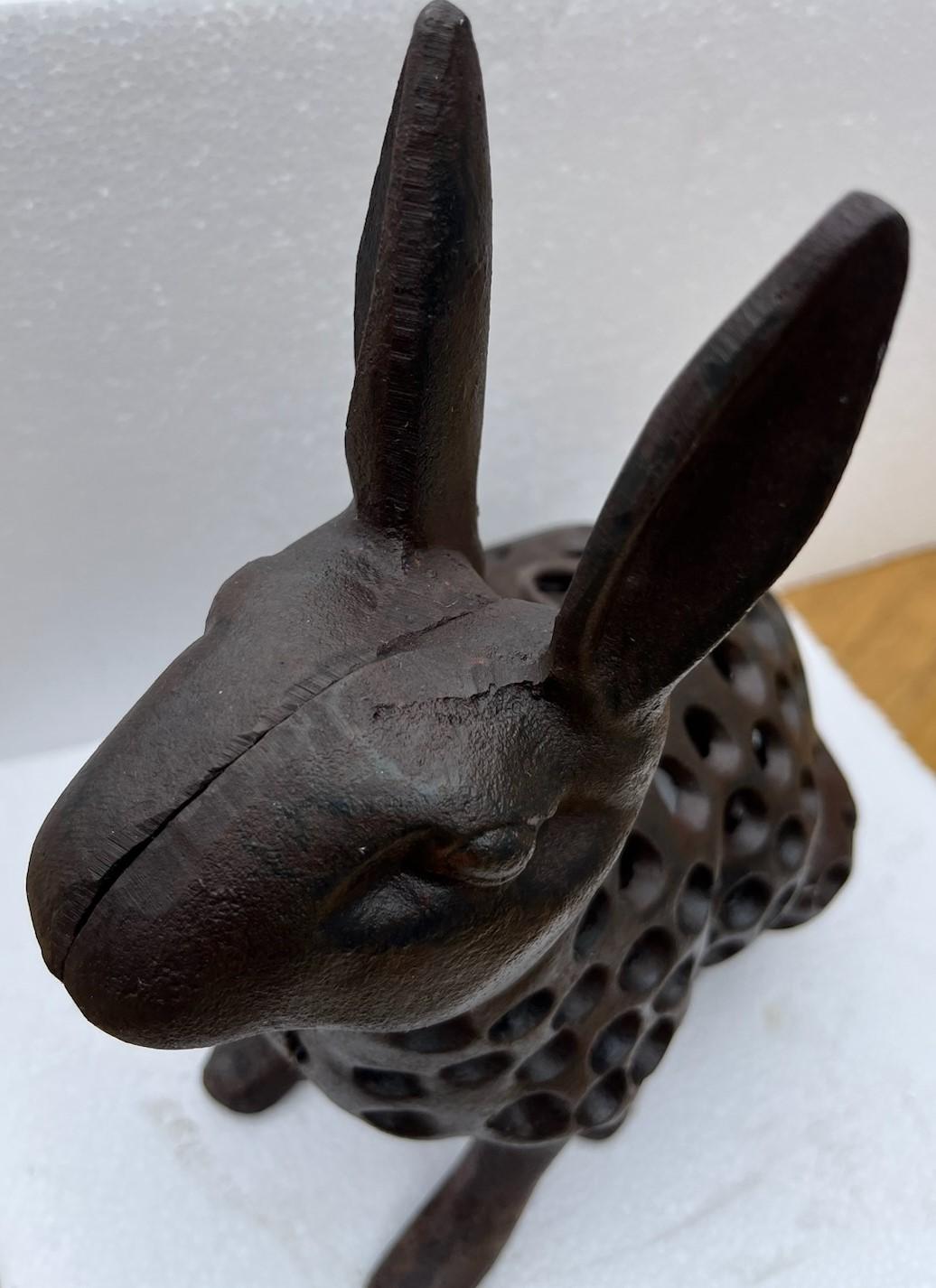 20th century Cast iron rabbit doorstop with a candle space to create a lantern. This heavy rabbit could even sit on the front porch or patio.