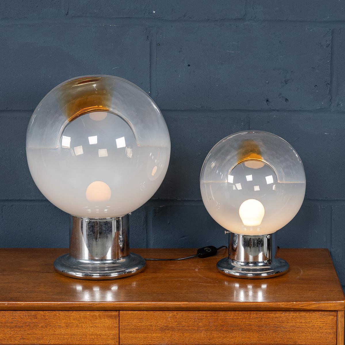 A delightful pair of graduated side table lamps designed by Gaetano Sciolari for Mazzega, made in the famous island of Murano, Venice, in Italy around the 1970s. The chrome base supports an opalescent shade that becomes transparent and is then