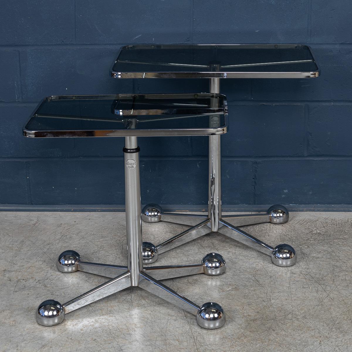 Two graduated Mid-Century Italian side tables by Arredamenti Allegri, made in Italy in the 1970s, exemplify the pinnacle of minimalist Italian design. Each table features an original signed smoked glass top in a graduated pair configuration,