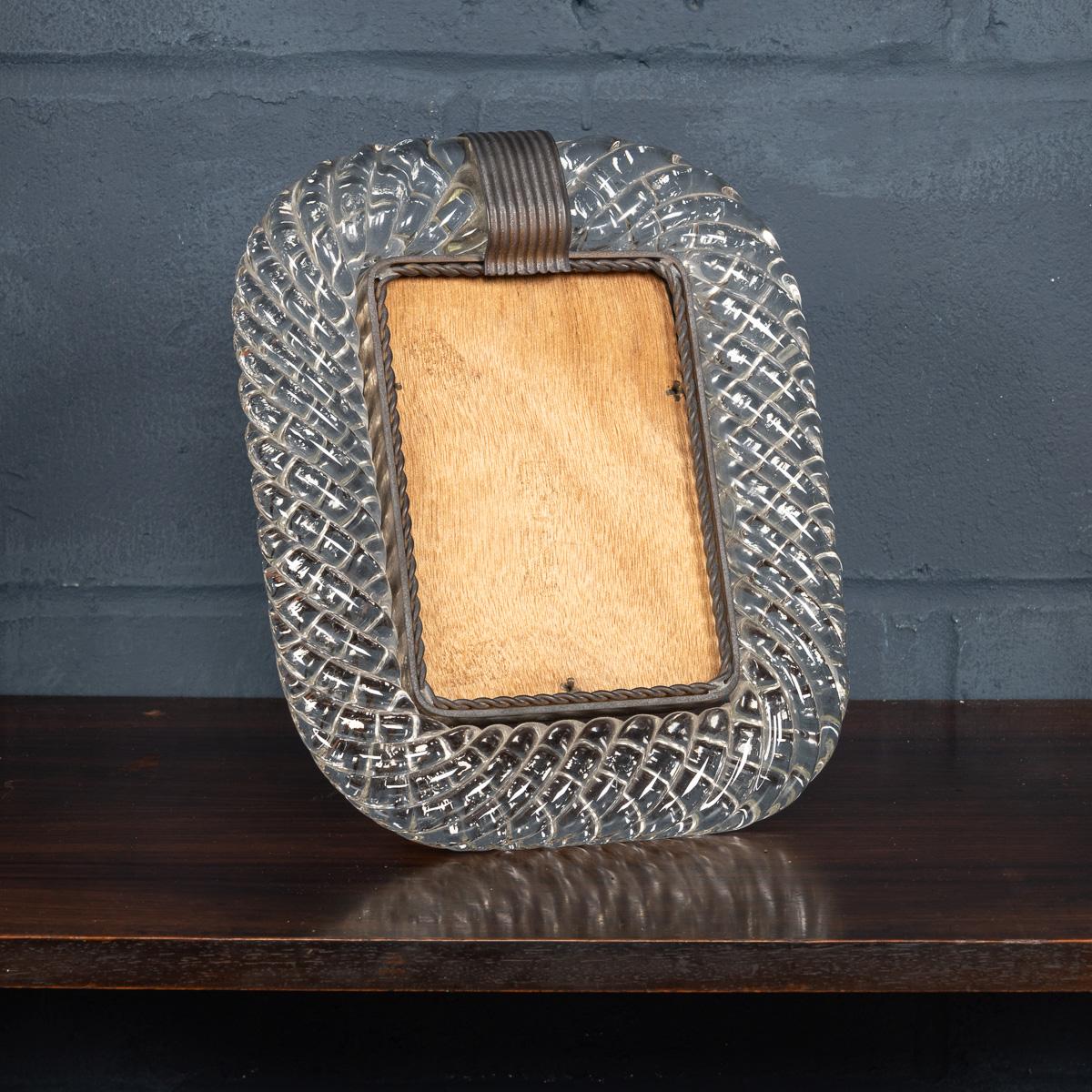 A beautiful glass mounted photograph frame attributable to the world renowned Venini in Venice, Italy. The twisted glass rope picture frame was manufactured around the middle of the 20th century and encapsulates Venini’s philosophy of elegance and