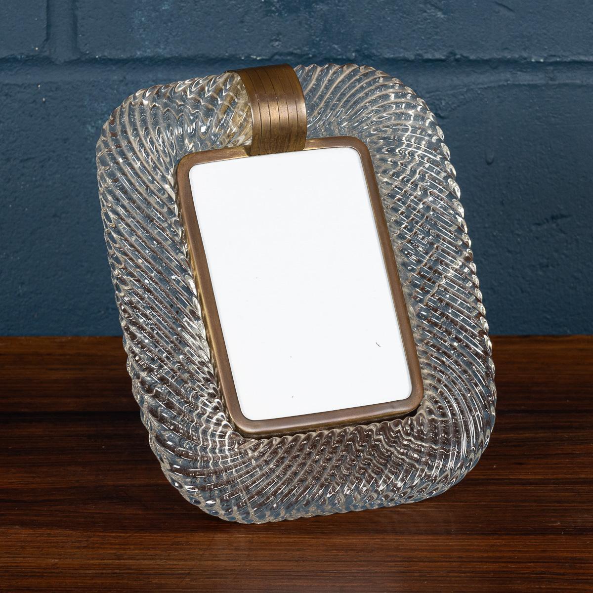 A beautiful glass mounted photograph frame attributable to the world renowned Venini in Venice, Italy. The twisted glass rope picture frame was manufactured around the middle of the 20th century and encapsulates Venini’s philosophy of elegance and
