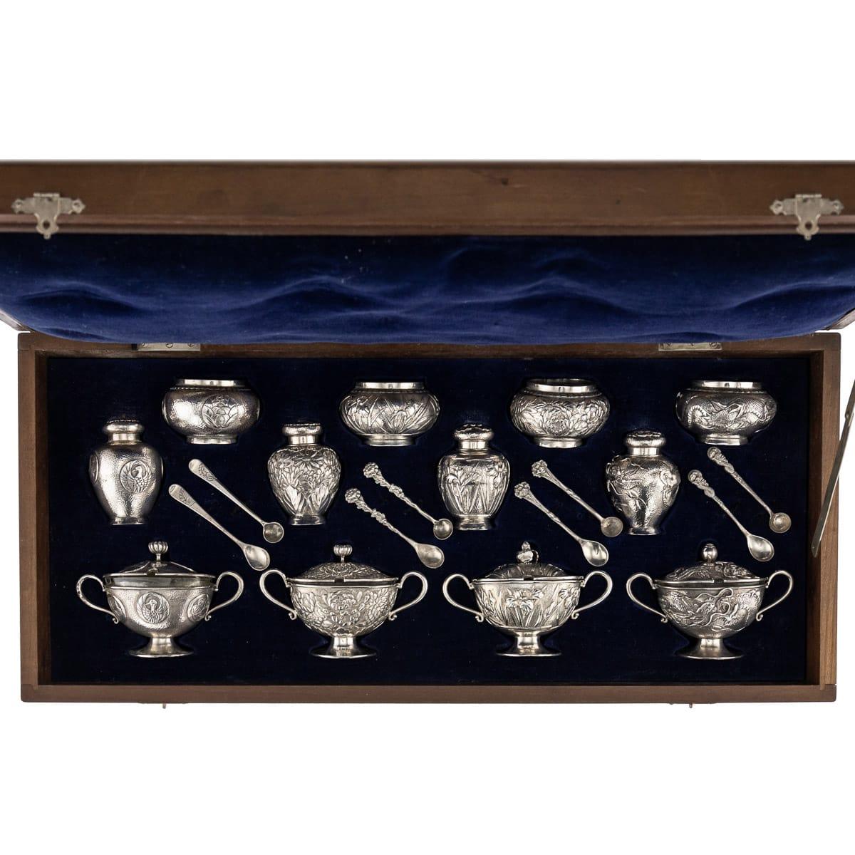 Antique early 20th century Japanese Meiji period solid silver large condiment set. Consisting of four mustard pots with spoons, salt cellars with spoons and pepper shakers, exceptional and magnificent quality, chased and embossed with compressed